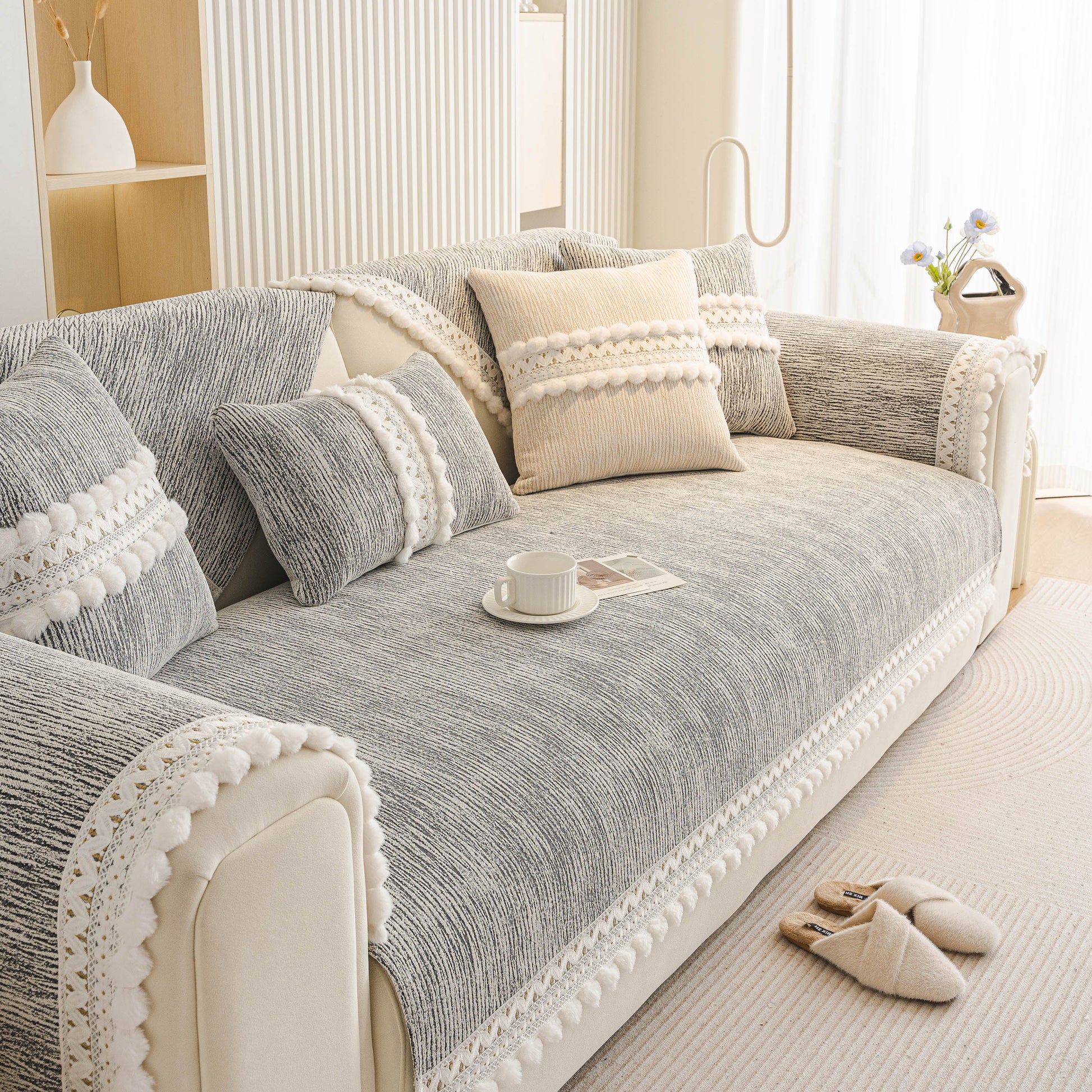 Soft Chenille Sectional Sofa Cover with Pom Pom Trim – Non-Slip Couch Protector on a modern style sofa in a bright living room.