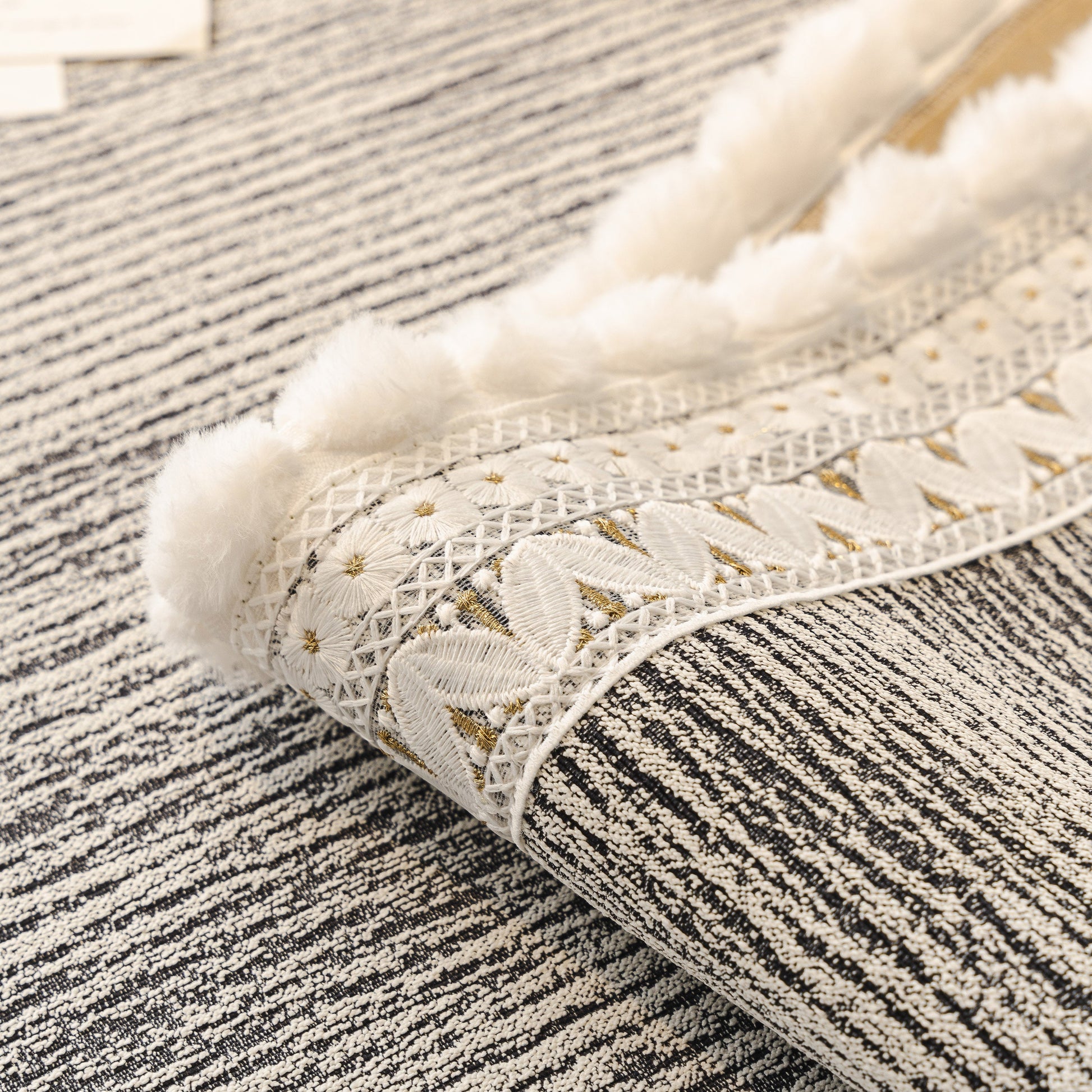 Soft Chenille Sectional Sofa Cover with Pom Pom Trim – Non-Slip Couch Protector with lace and pom pom details.