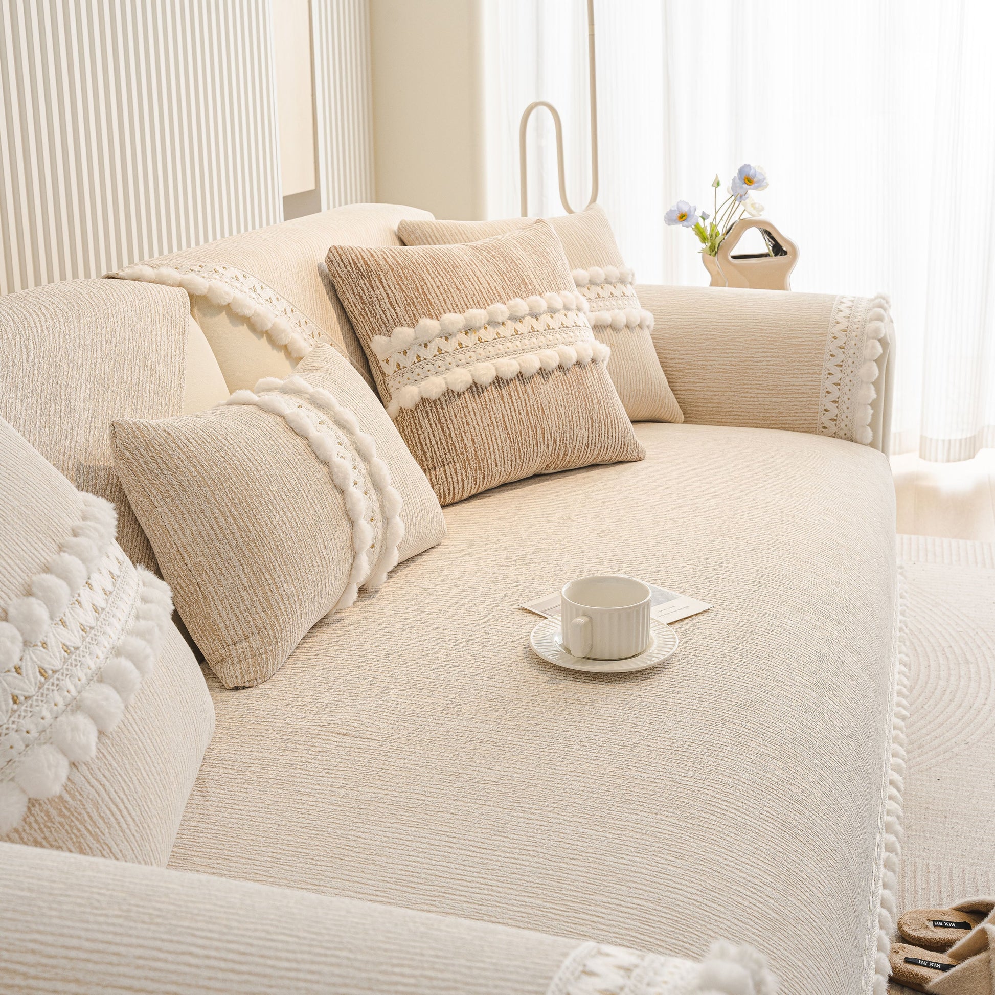 Soft Chenille Sectional Sofa Cover with Pom Pom Trim – Non-Slip Couch Protector in a cozy modern living room setting.