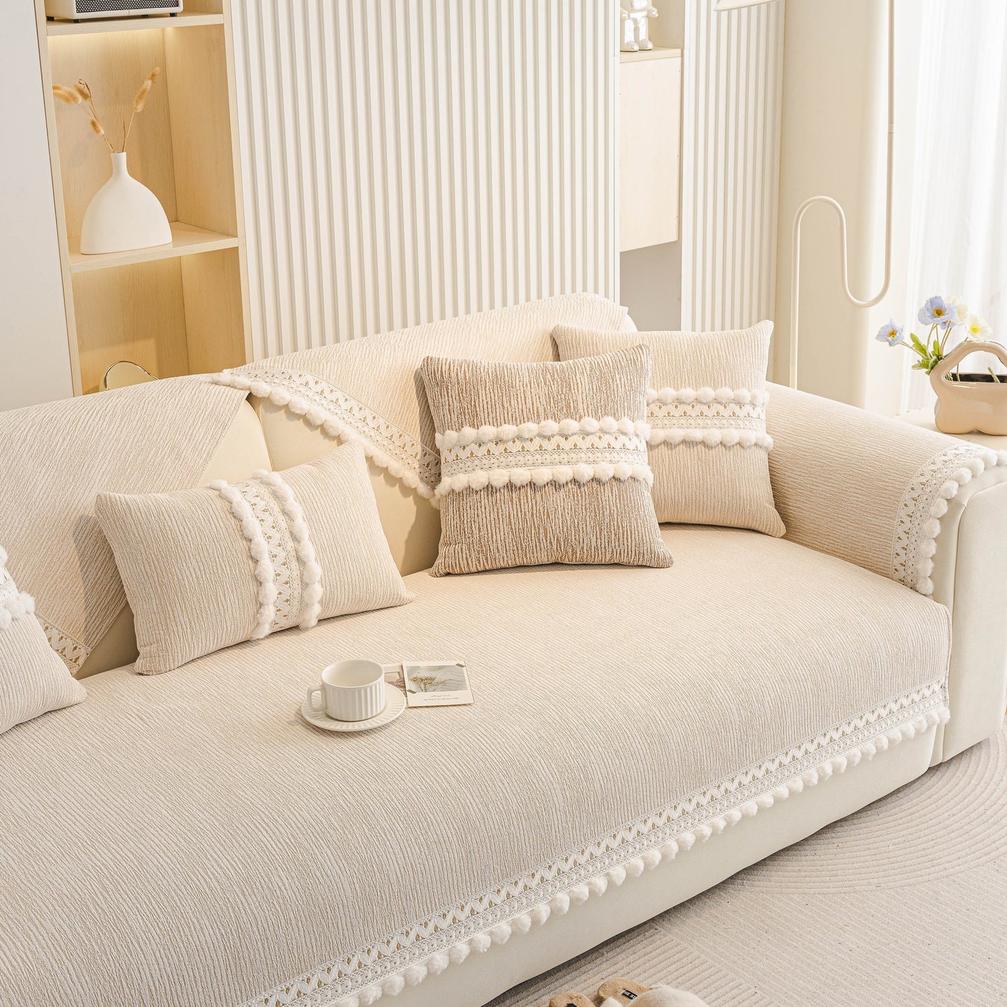 Soft Chenille Sectional Sofa Cover with Pom Pom Trim – Non-Slip Couch Protector displayed on a beige sofa in a modern living room.