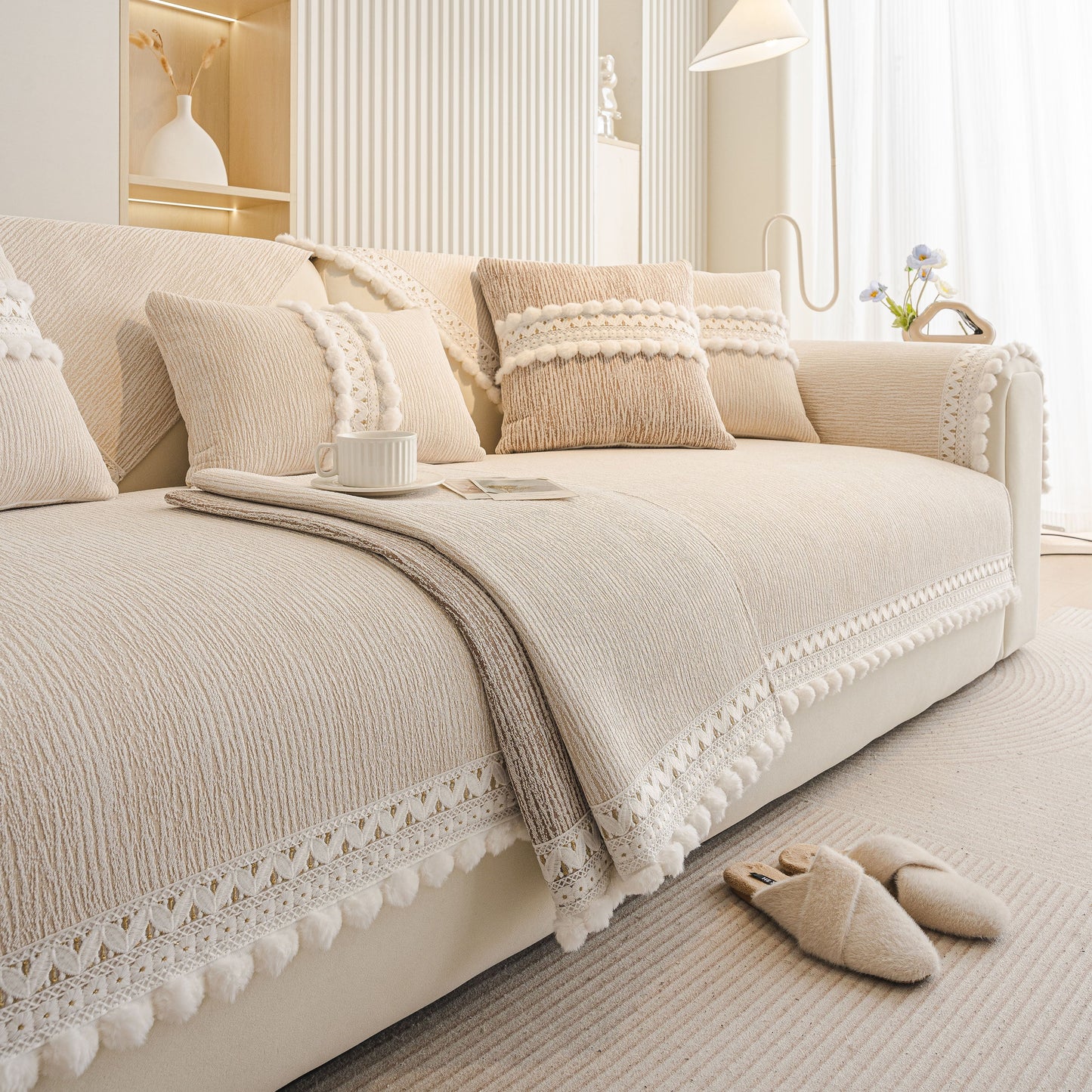 Soft Chenille Sectional Sofa Cover with Pom Pom Trim – Non-Slip Couch Protector on a beige sofa with decorative pillows