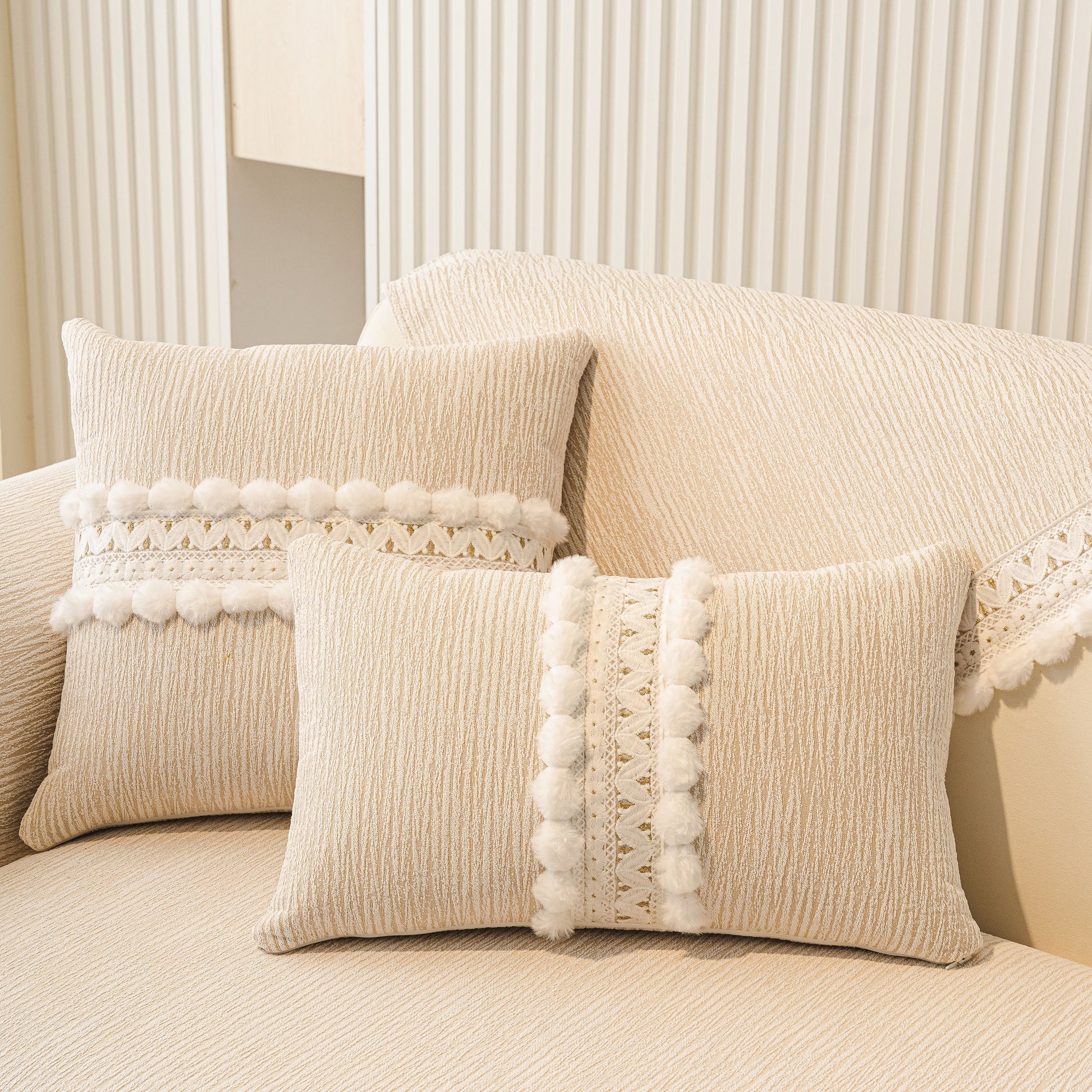 Soft Chenille Sectional Sofa Cover with Pom Pom Trim – Non-Slip Couch Protector displayed on sofa with pillows.
