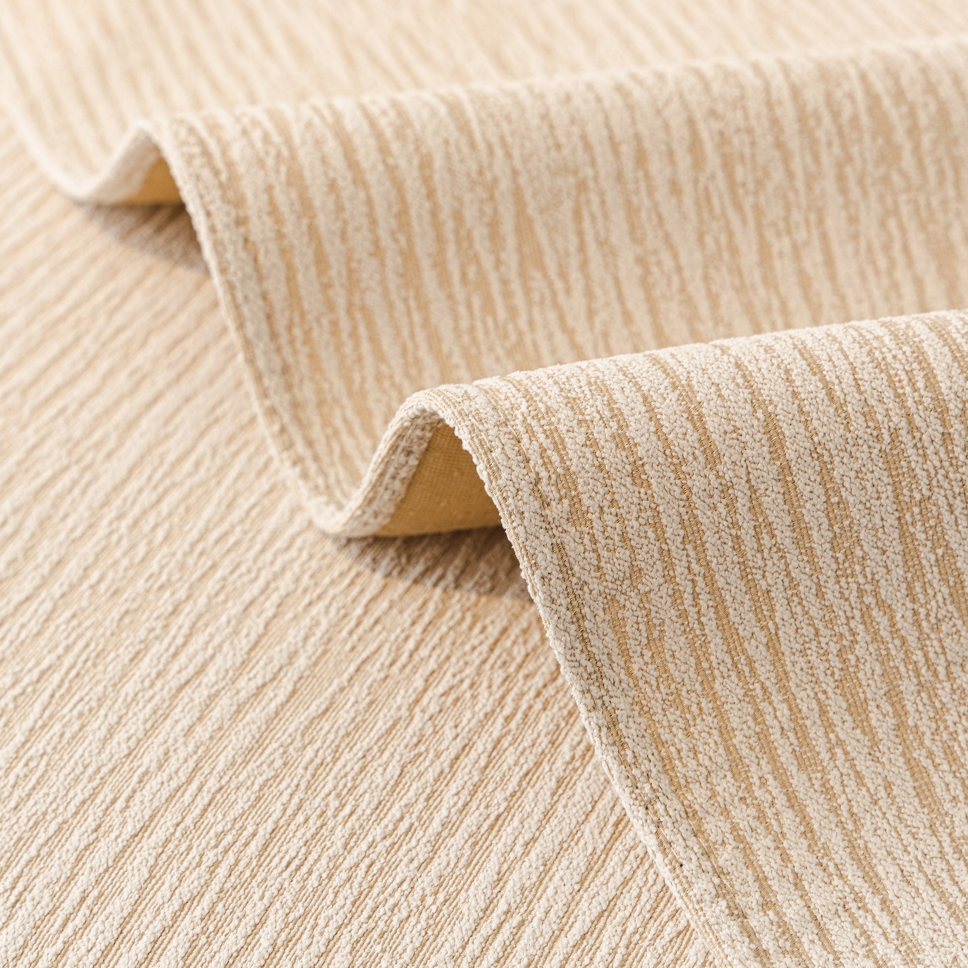 Close-up of Soft Chenille Sectional Sofa Cover with Pom Pom Trim – Non-Slip Couch Protector showing textured fabric and subtle stripes.