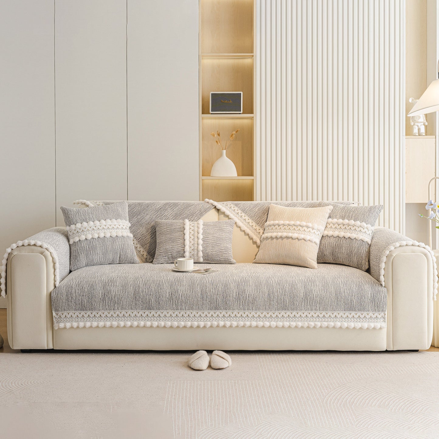 Soft Chenille Sectional Sofa Cover with Pom Pom Trim – Non-Slip Couch Protector displayed on a modern sofa in a light interior