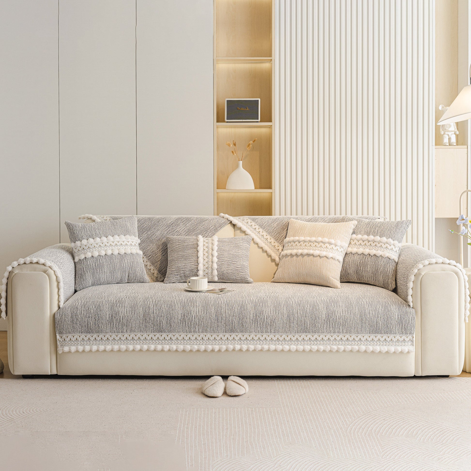 Soft Chenille Sectional Sofa Cover with Pom Pom Trim – Non-Slip Couch Protector displayed on a modern sofa in a light interior