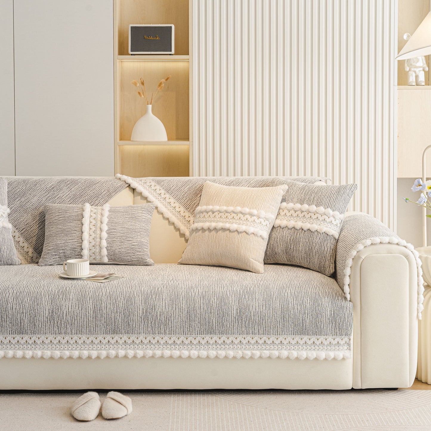 Soft Chenille Sectional Sofa Cover with Pom Pom Trim – Non-Slip Couch Protector on a white sofa in a modern living room.
