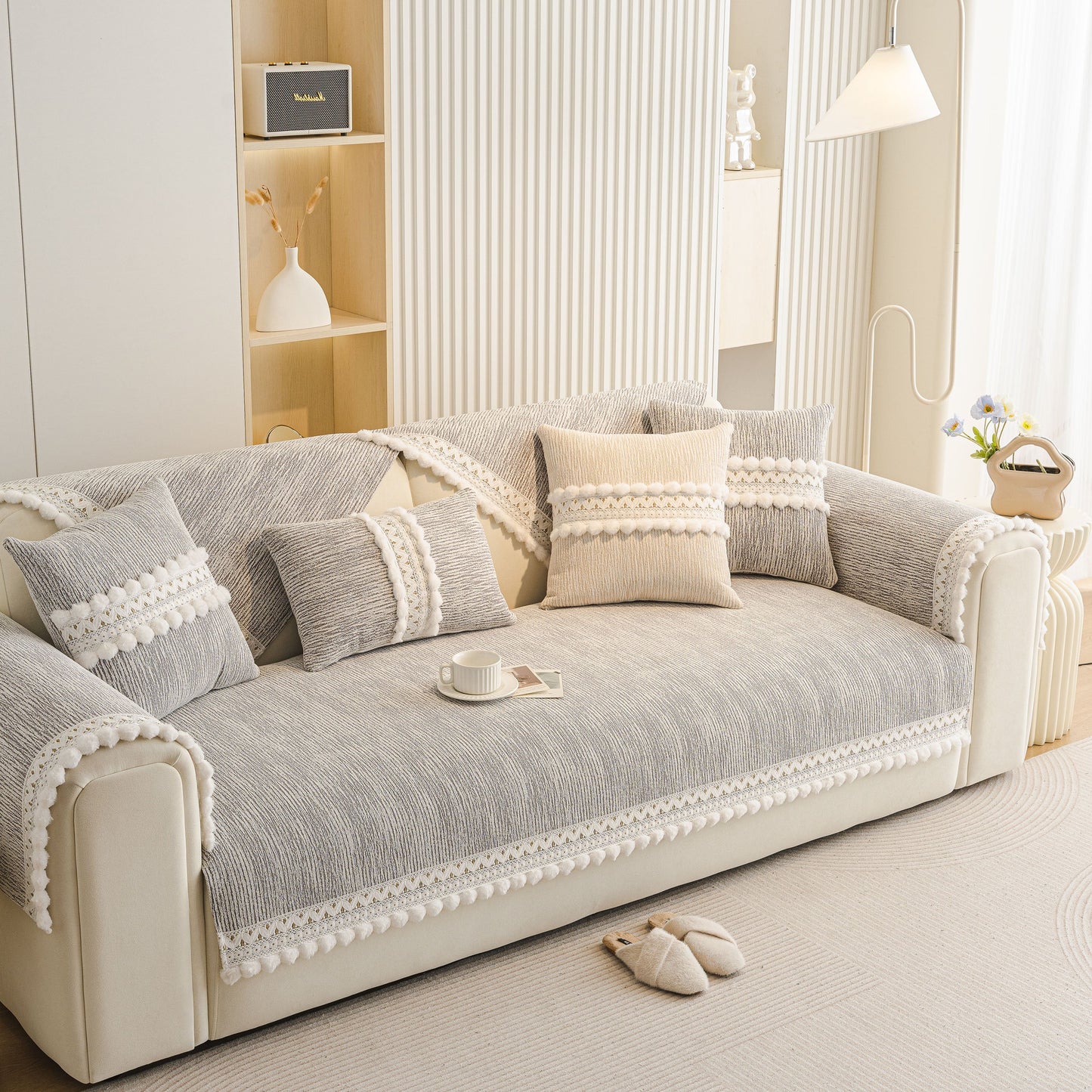 Soft Chenille Sectional Sofa Cover with Pom Pom Trim – Non-Slip Couch Protector displayed on a modern sofa in a light interior.