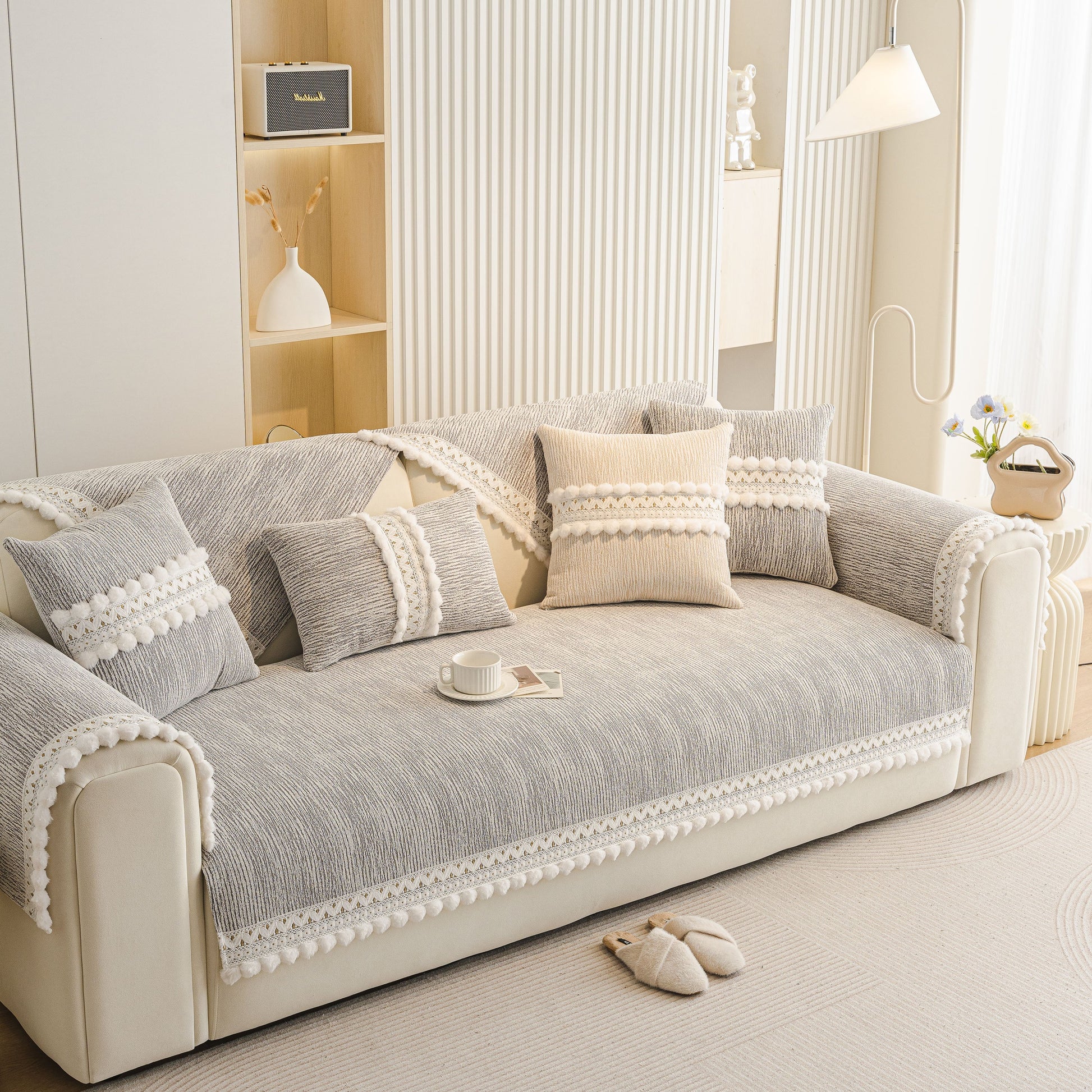 Soft Chenille Sectional Sofa Cover with Pom Pom Trim – Non-Slip Couch Protector displayed on a modern sofa in a light interior.