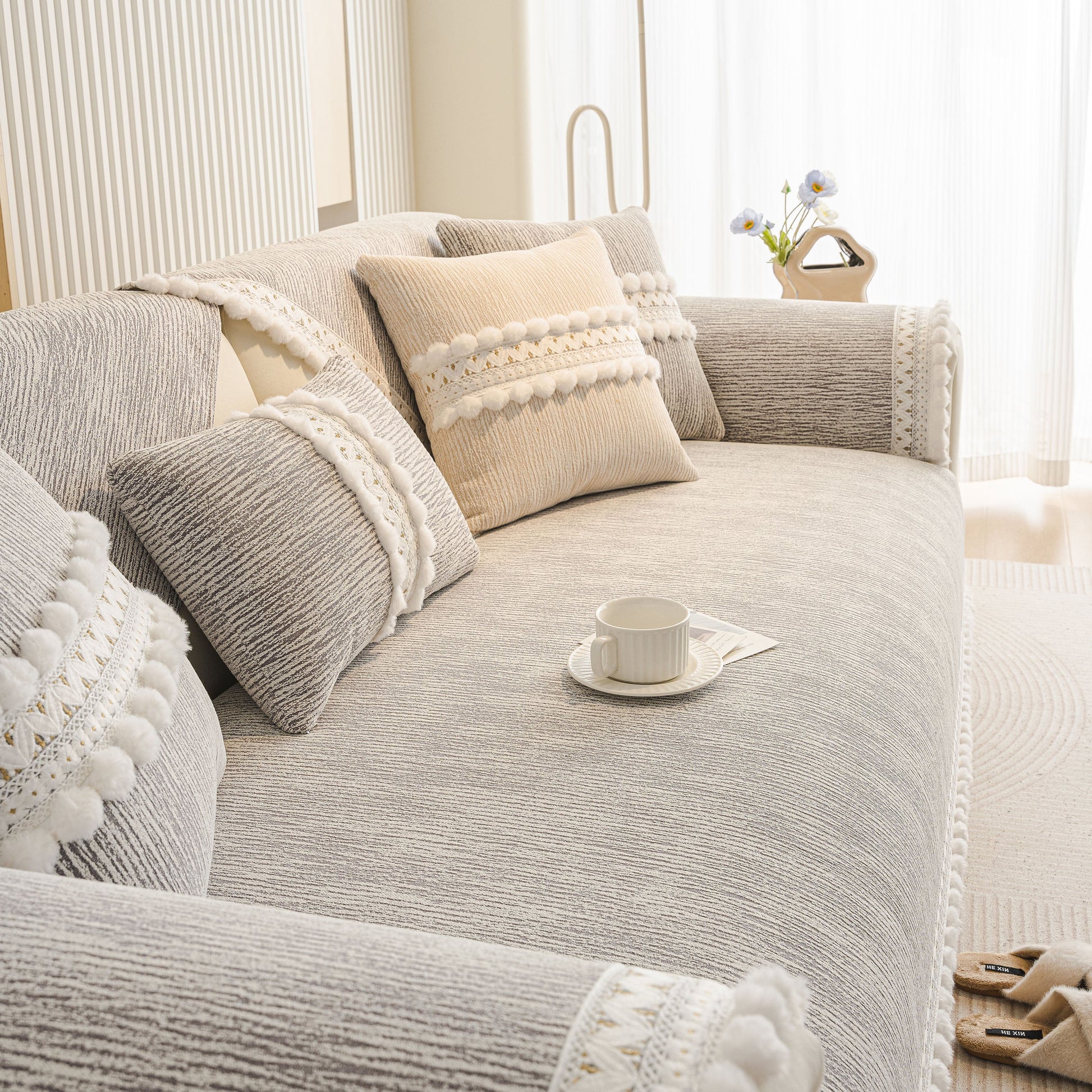 Soft Chenille Sectional Sofa Cover with Pom Pom Trim – Non-Slip Couch Protector on a stylish living room sofa.