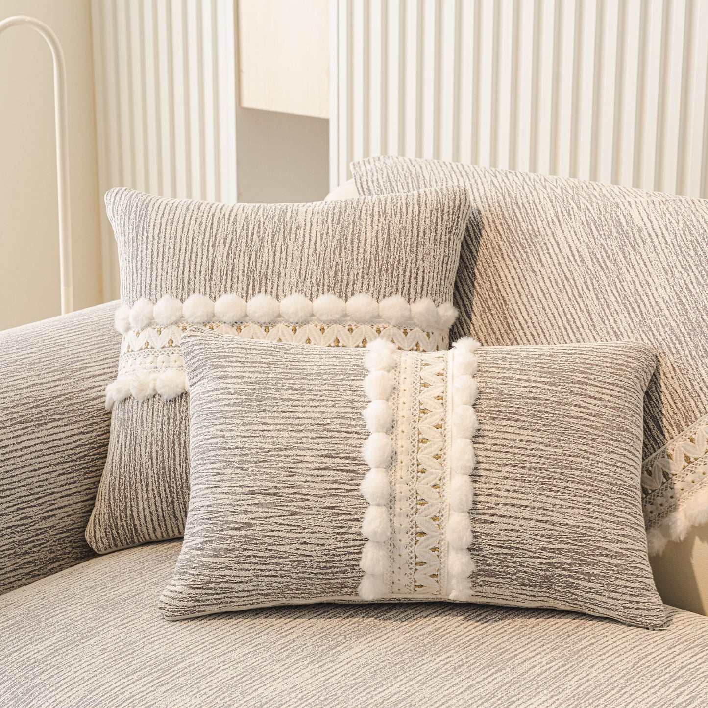 Soft Chenille Sectional Sofa Cover with Pom Pom Trim – Non-Slip Couch Protector displaying decorative pillows with pom pom and lace trim.
