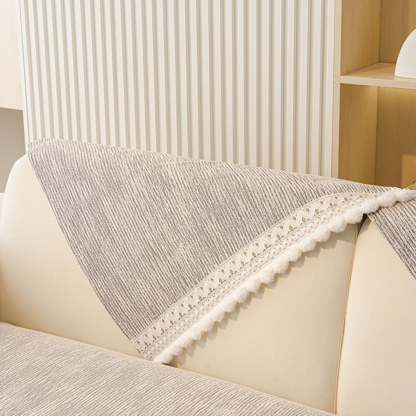 Soft Chenille Sectional Sofa Cover with Pom Pom Trim – Non-Slip Couch Protector in grey, featuring pom pom fringe and stripe texture.