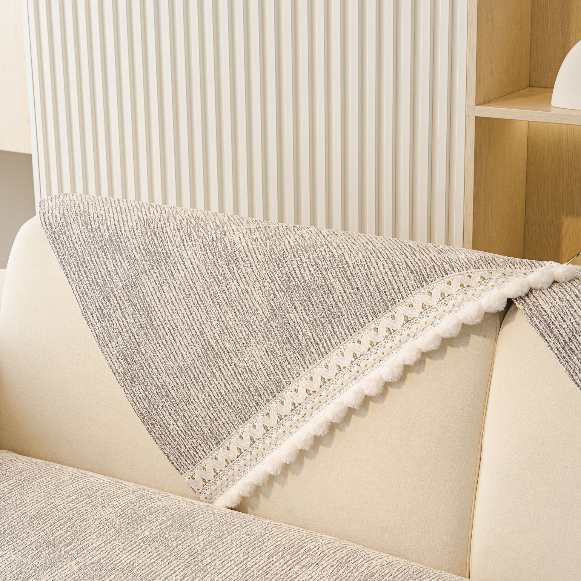 Soft Chenille Sectional Sofa Cover with Pom Pom Trim – Non-Slip Couch Protector in grey, featuring pom pom fringe and stripe texture.