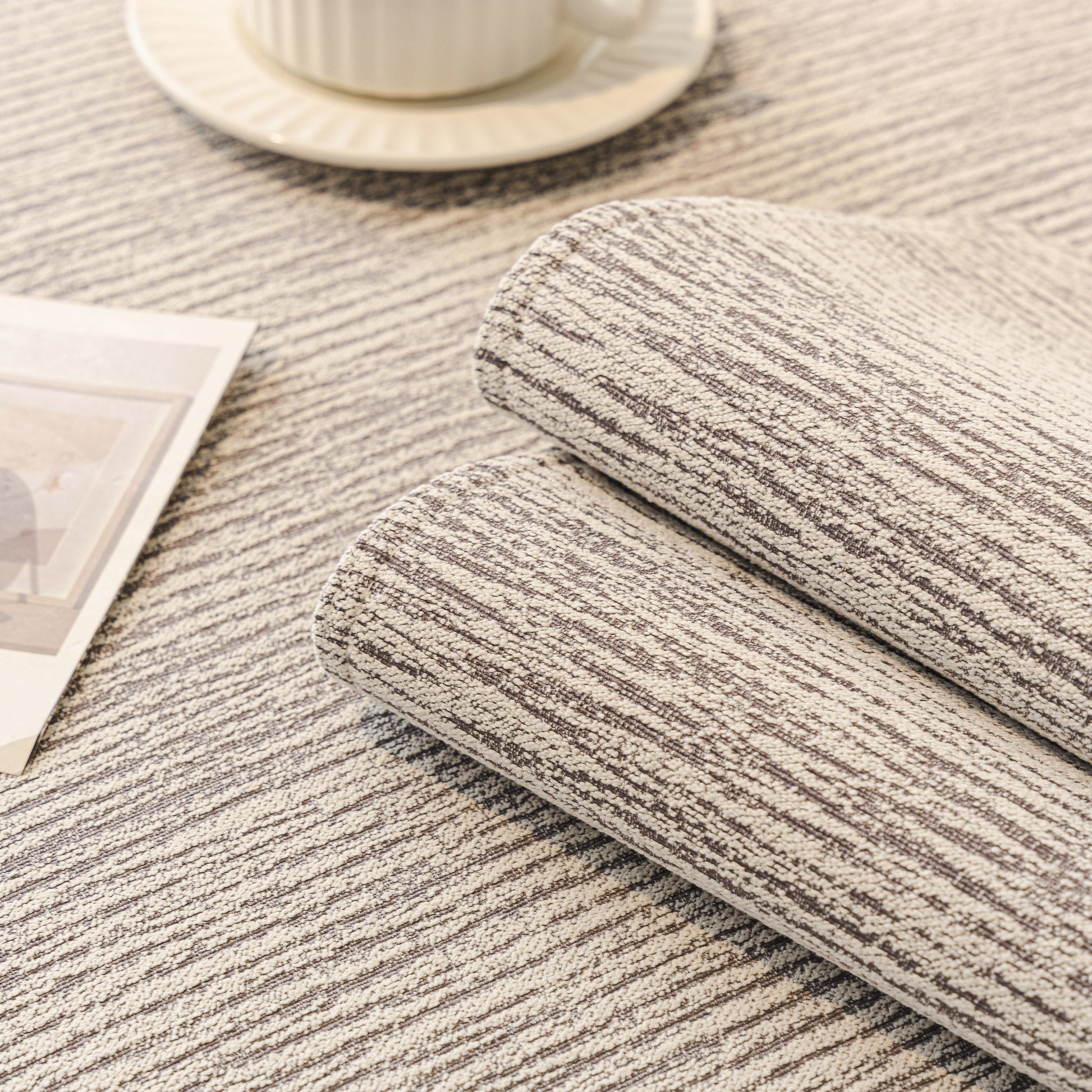 Close-up of Soft Chenille Sectional Sofa Cover with Pom Pom Trim – Non-Slip Couch Protector showing raised stripes texture.