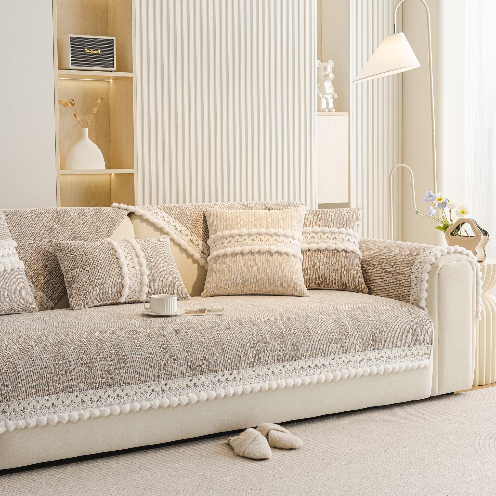 Soft Chenille Sectional Sofa Cover with Pom Pom Trim – Non-Slip Couch Protector on beige sofa with decorative pillows.