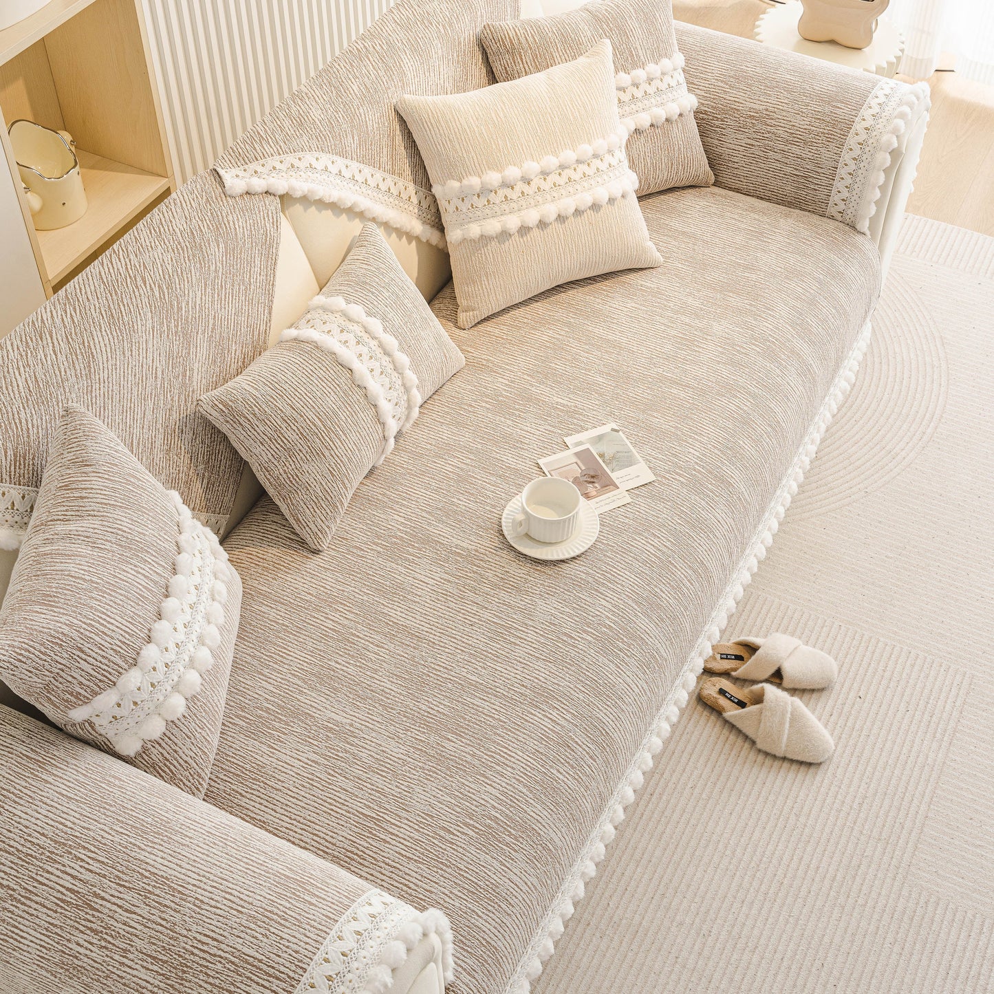 Soft Chenille Sectional Sofa Cover with Pom Pom Trim – Non-Slip Couch Protector on a modern sofa with decorative pillows.