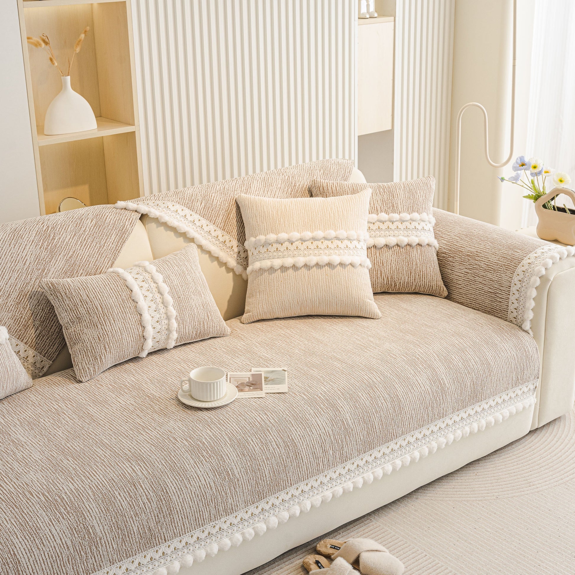 Soft Chenille Sectional Sofa Cover with Pom Pom Trim – Non-Slip Couch Protector in a modern light European-style interior.