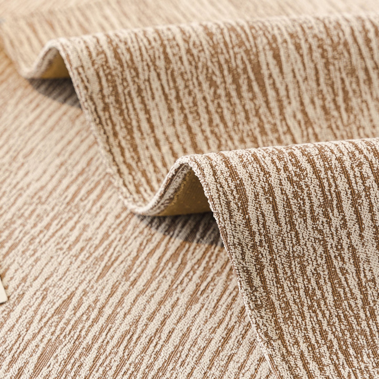 Close-up of Soft Chenille Sectional Sofa Cover with Pom Pom Trim – Non-Slip Couch Protector in beige with subtle vertical striping.