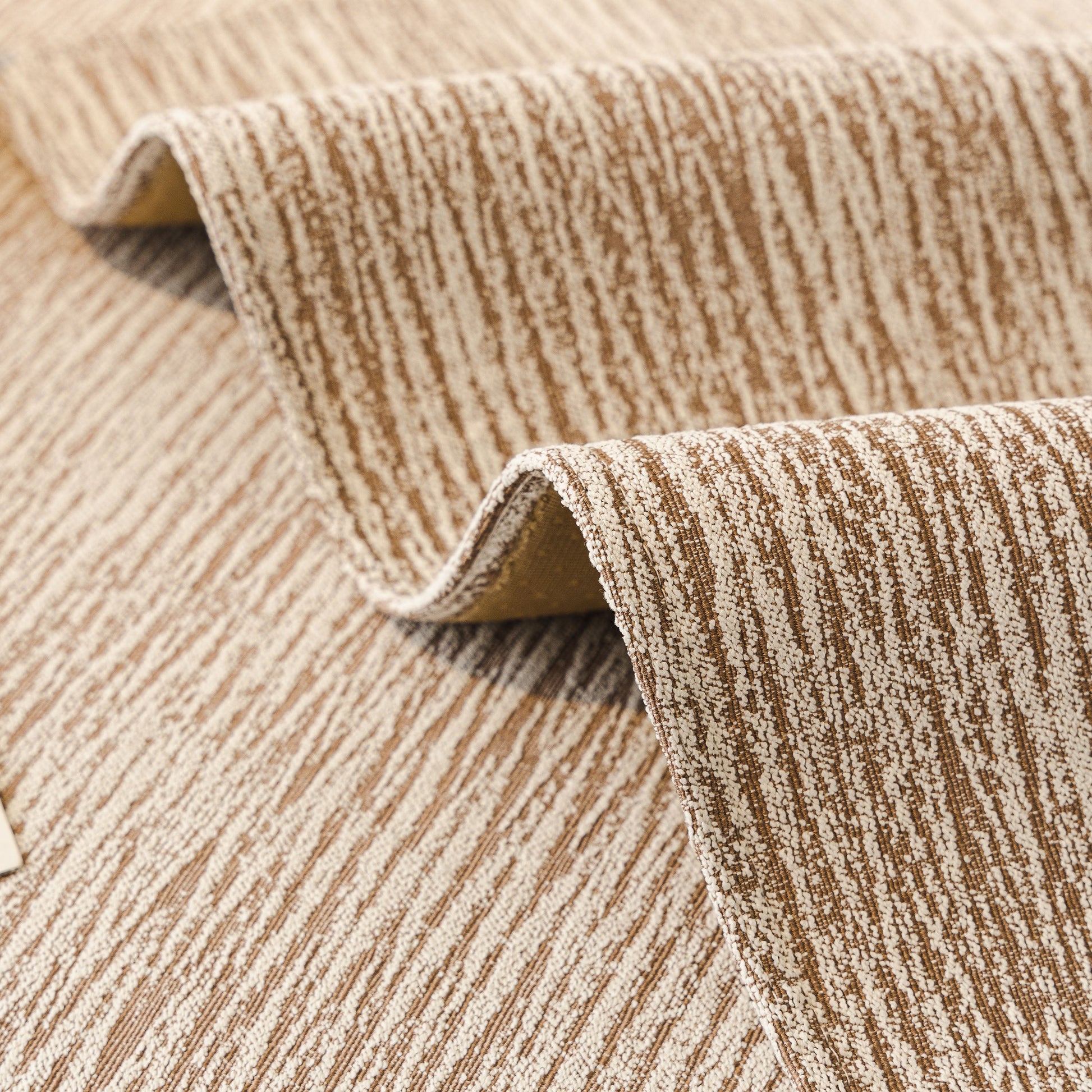 Close-up of Soft Chenille Sectional Sofa Cover with Pom Pom Trim – Non-Slip Couch Protector in beige with subtle vertical striping.