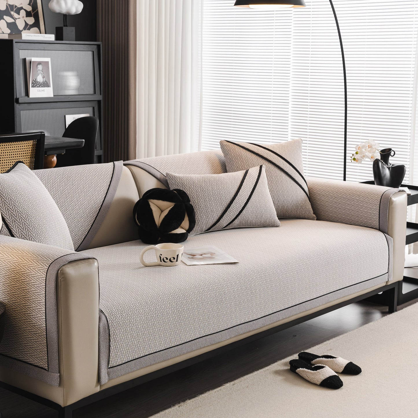 Modern living room featuring a stylish sofa with decorative cushions and minimalist decor.