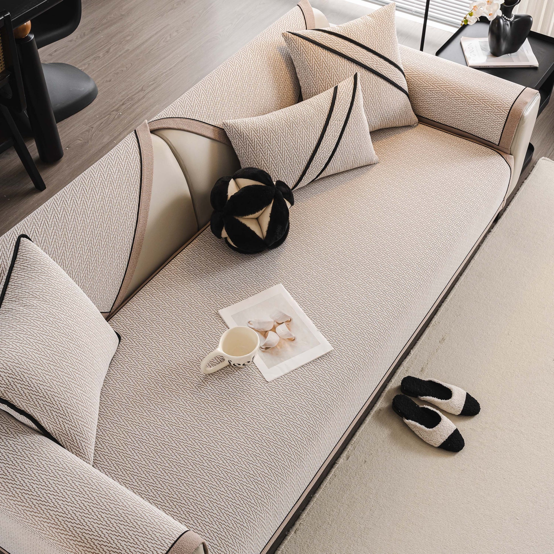 Herringbone Couch Protector for Pets, Non-Slip Washable Sectional Couch Covers displayed on a modern sofa with pillows and slippers.