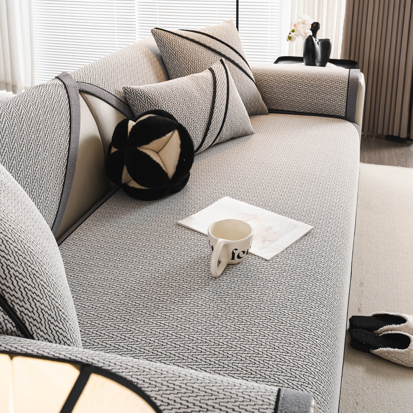 Herringbone Couch Protector for Pets, Non-Slip Washable Sectional Couch Covers on a stylish modern sofa with decorative pillows.