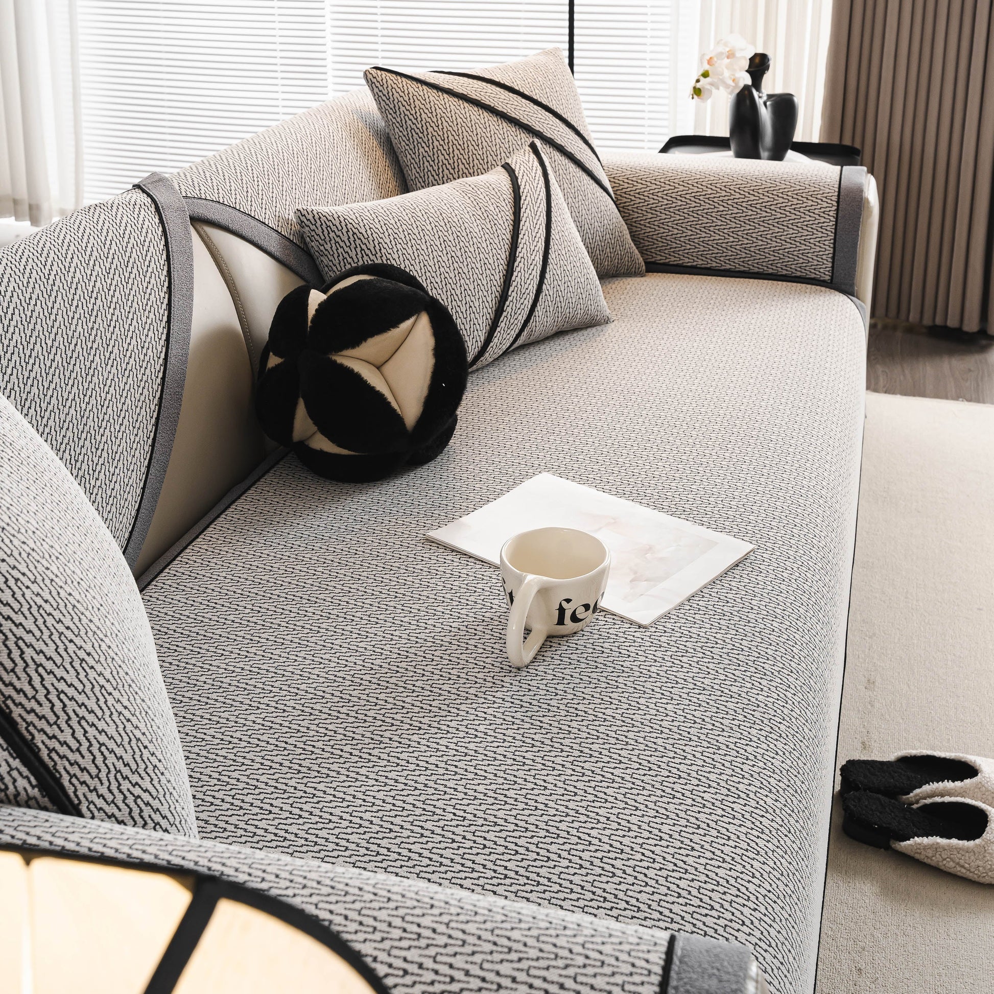 Herringbone Couch Protector for Pets, Non-Slip Washable Sectional Couch Covers on a stylish modern sofa with decorative pillows.