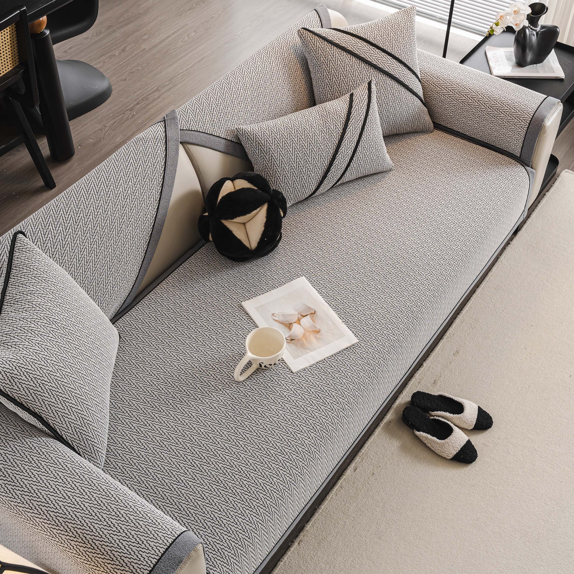 Herringbone Couch Protector for Pets, Non-Slip Washable Sectional Couch Covers on a grey sofa with matching pillows and slippers