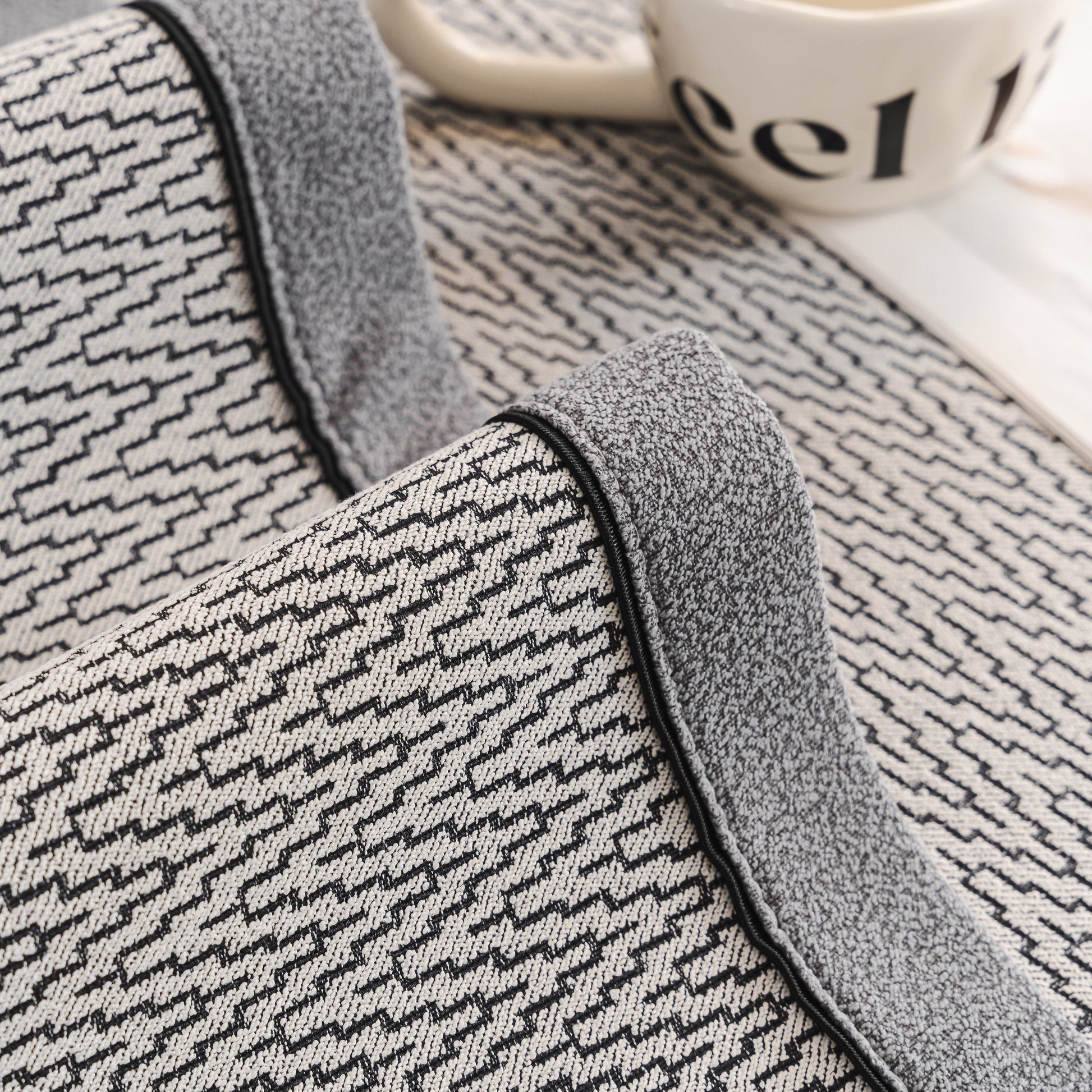Close-up of Herringbone Couch Protector for Pets, Non-Slip Washable Sectional Couch Covers with piped edges and herringbone texture.