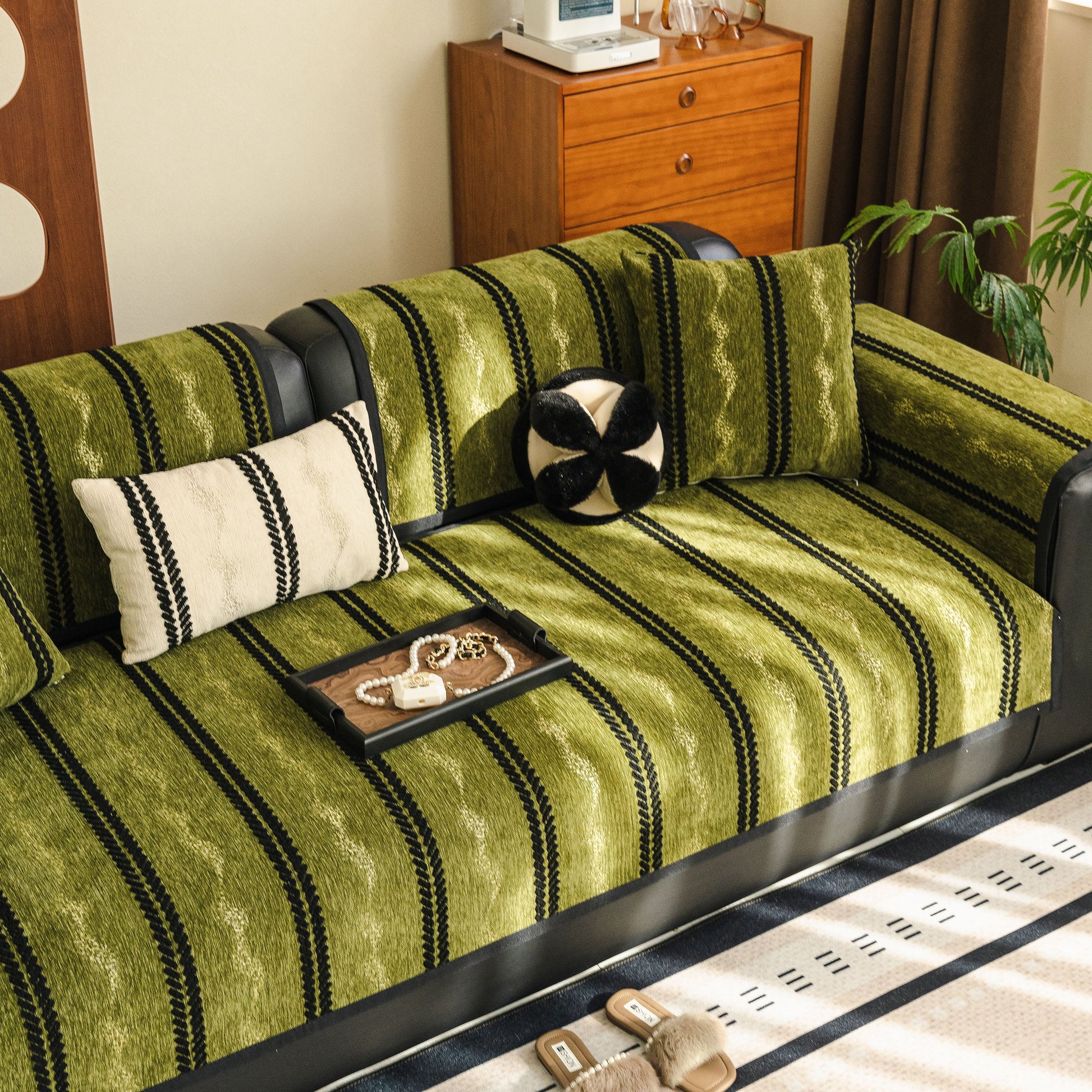 Non-Slip Sofa Cover with Thick Chenille Texture Woven Stripe Couch Protector Throw on green and black sofa with pillows.