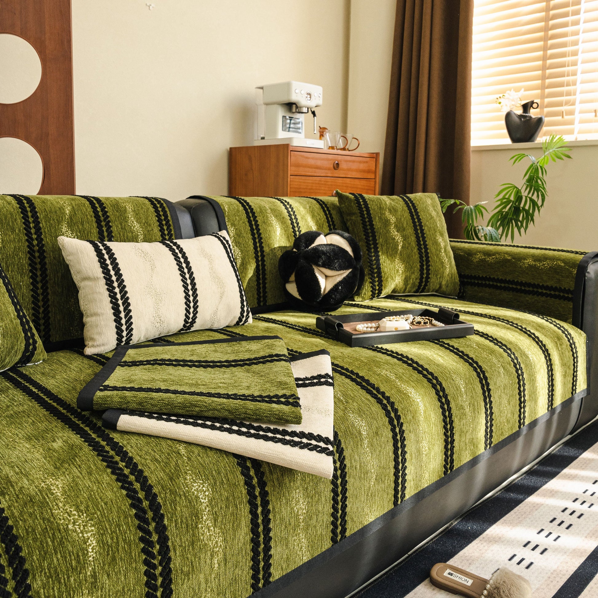 Non-Slip Sofa Cover with Thick Chenille Texture Woven Stripe Couch Protector Throw on a green couch with decorative pillows.