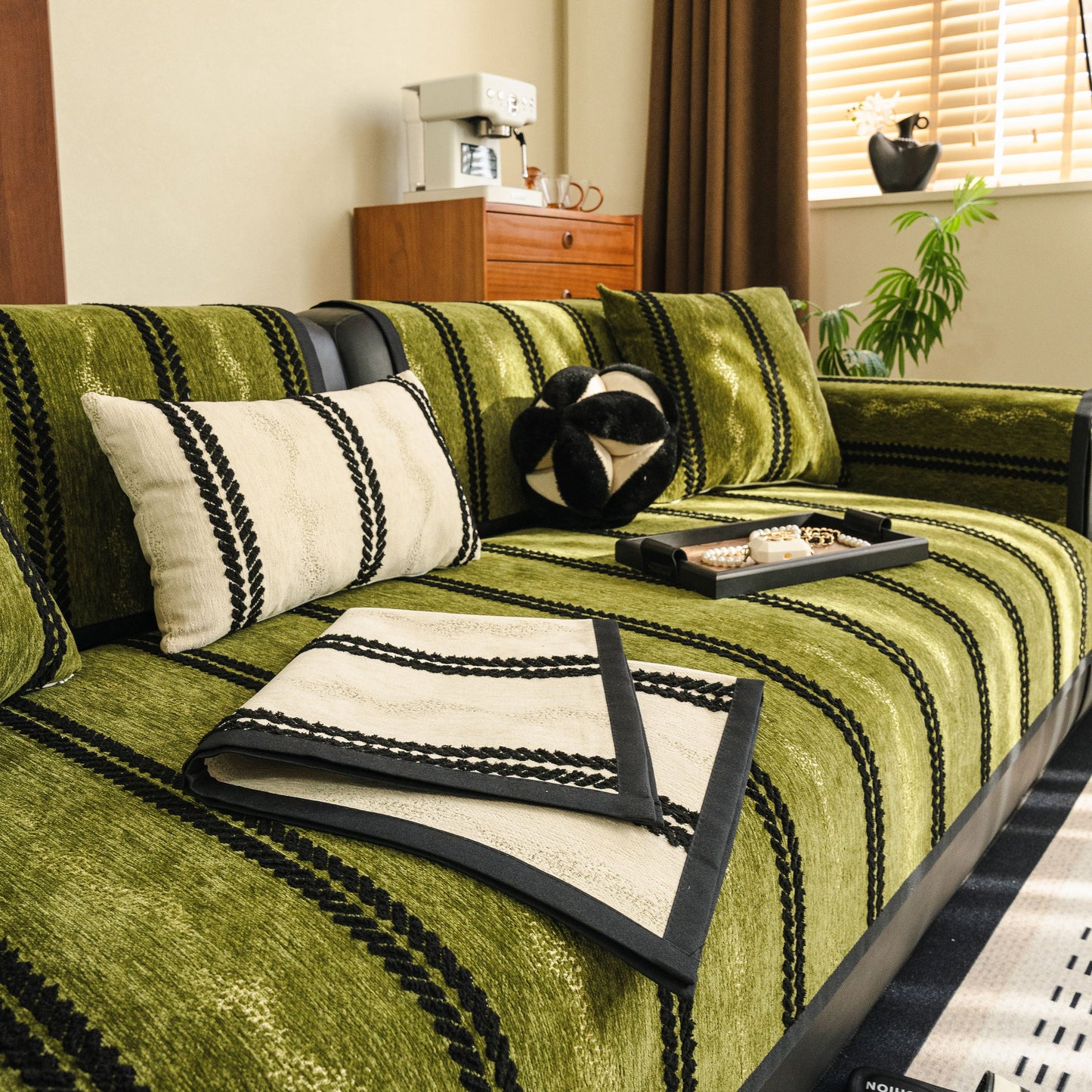 Non-Slip Sofa Cover with Thick Chenille Texture Woven Stripe Couch Protector Throw on a sofa with cushions and decor.