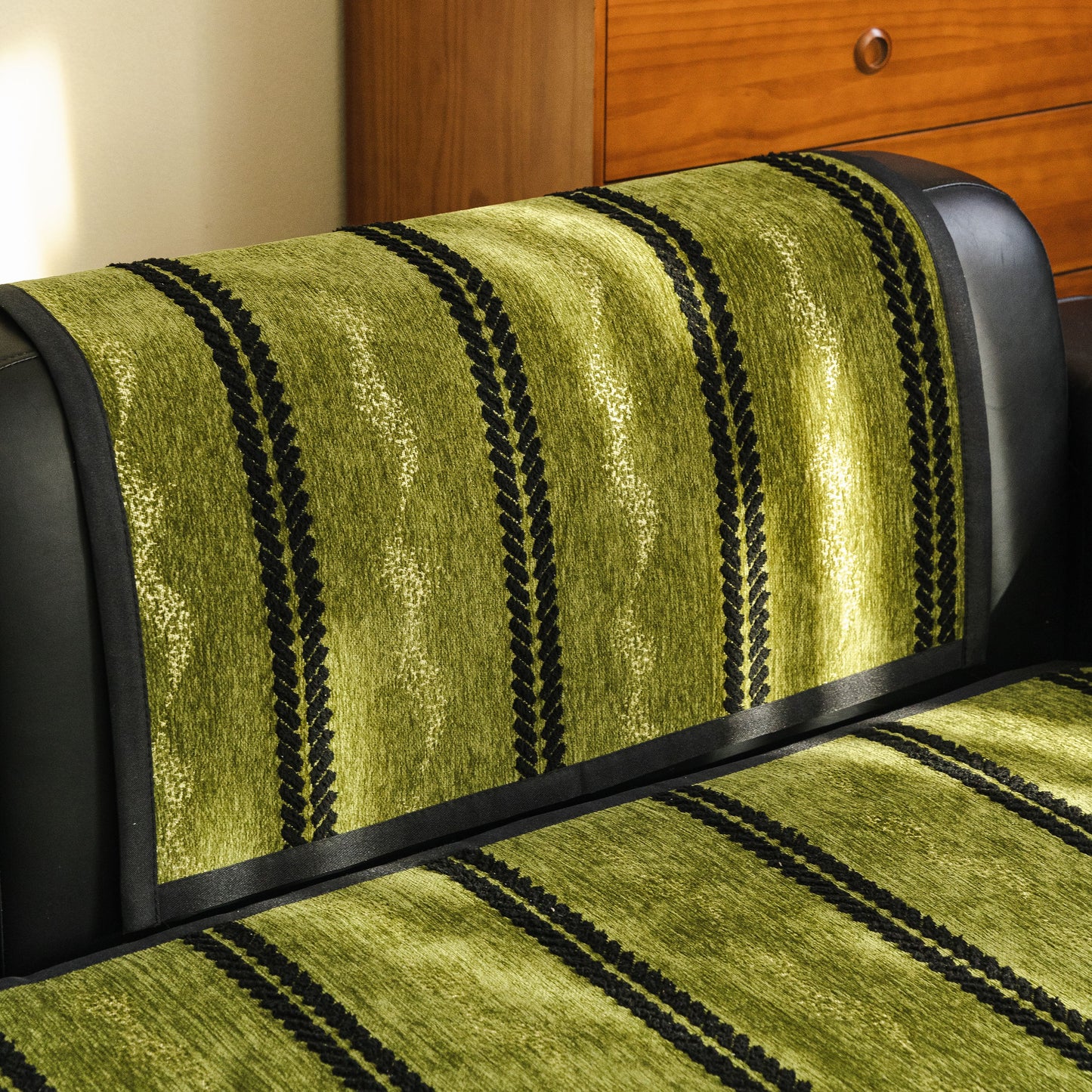 Non-Slip Sofa Cover with Thick Chenille Texture Woven Stripe Couch Protector Throw in green on a black leather sofa