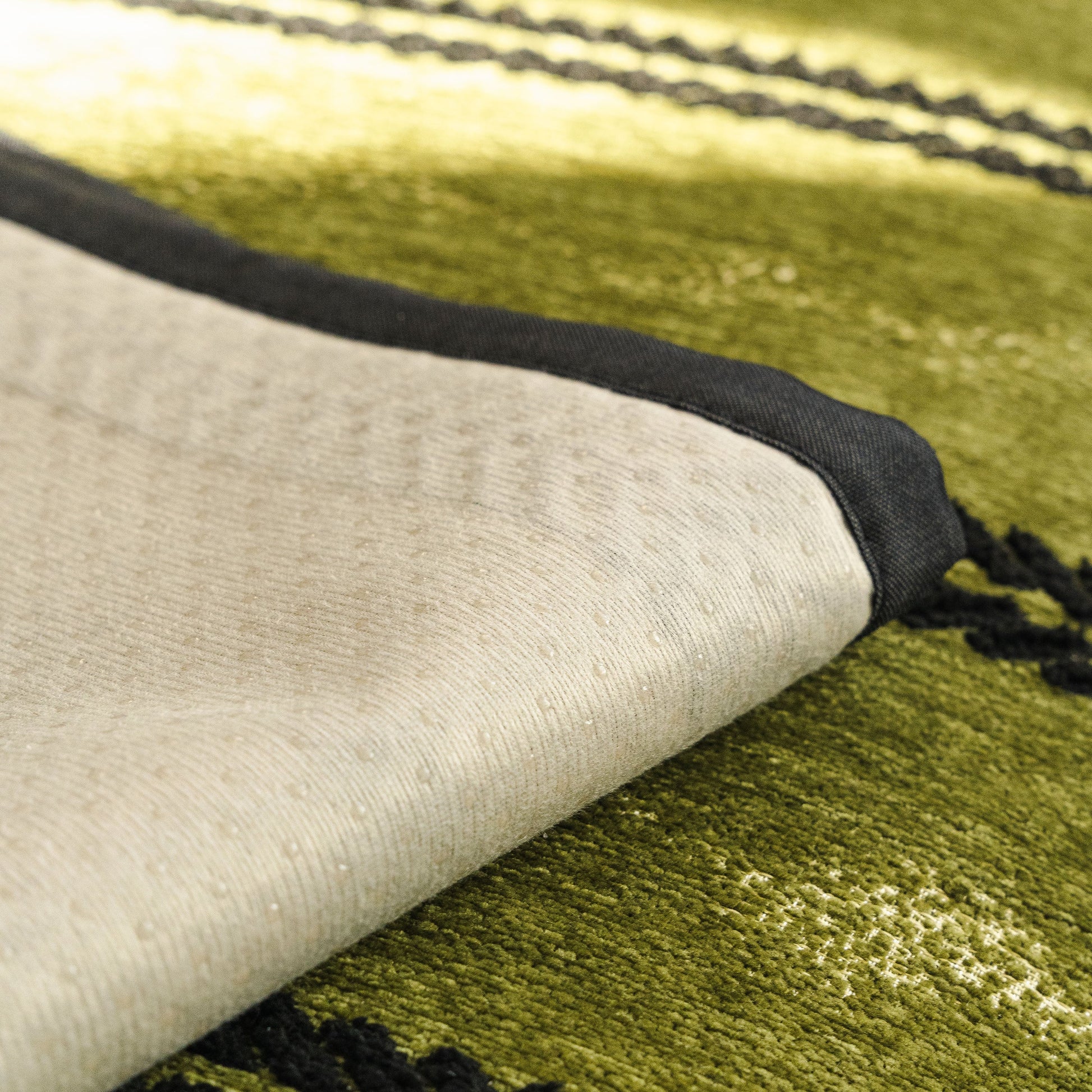 Non-Slip Sofa Cover with Thick Chenille Texture Woven Stripe Couch Protector Throw showing silicone anti-slip backing on green surface