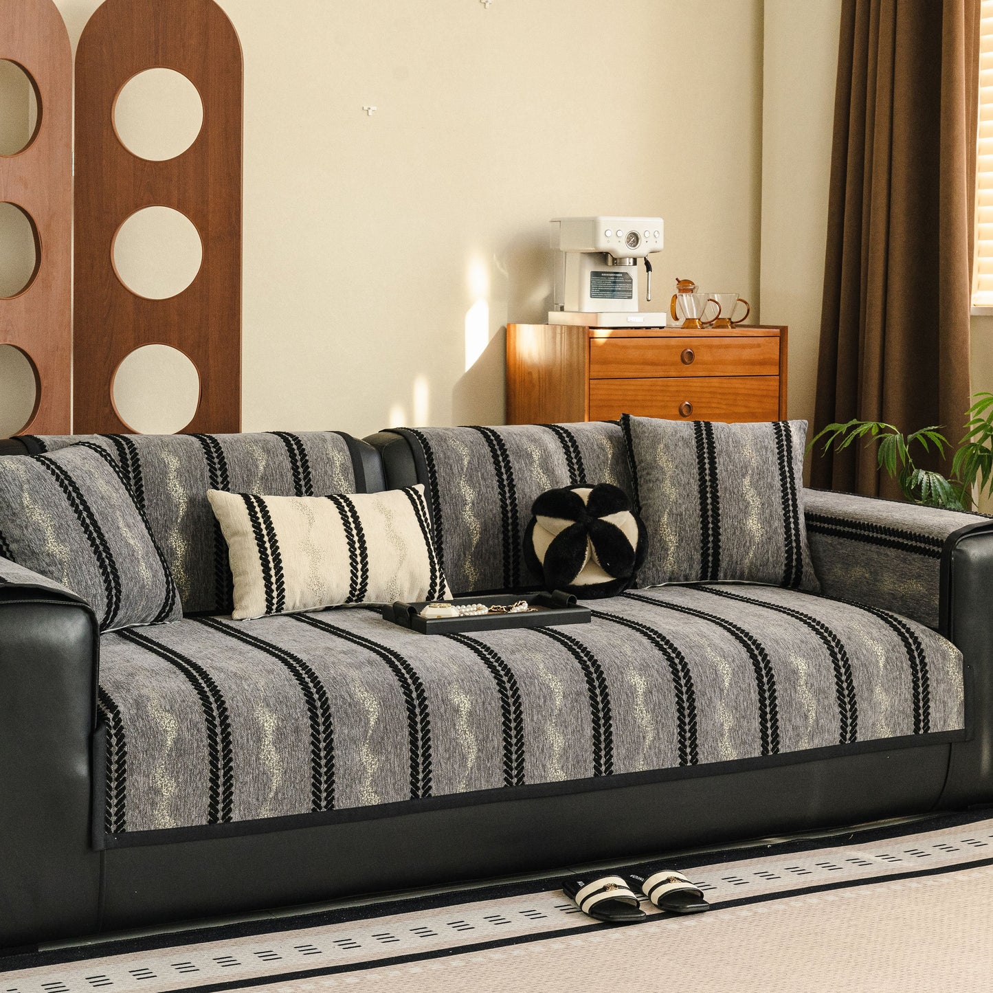 Non-Slip Sofa Cover with Thick Chenille Texture Woven Stripe Couch Protector Throw on a black leather sofa