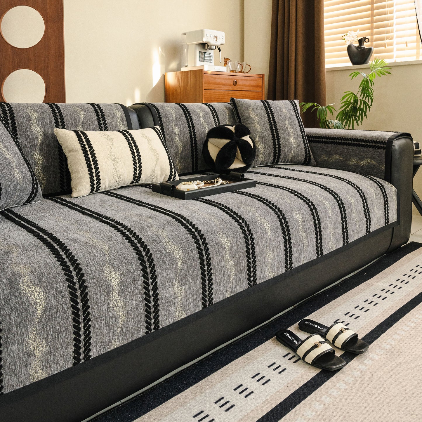 Living room sofa with Non-Slip Sofa Cover with Thick Chenille Texture Woven Stripe Couch Protector Throw and decorative pillows.