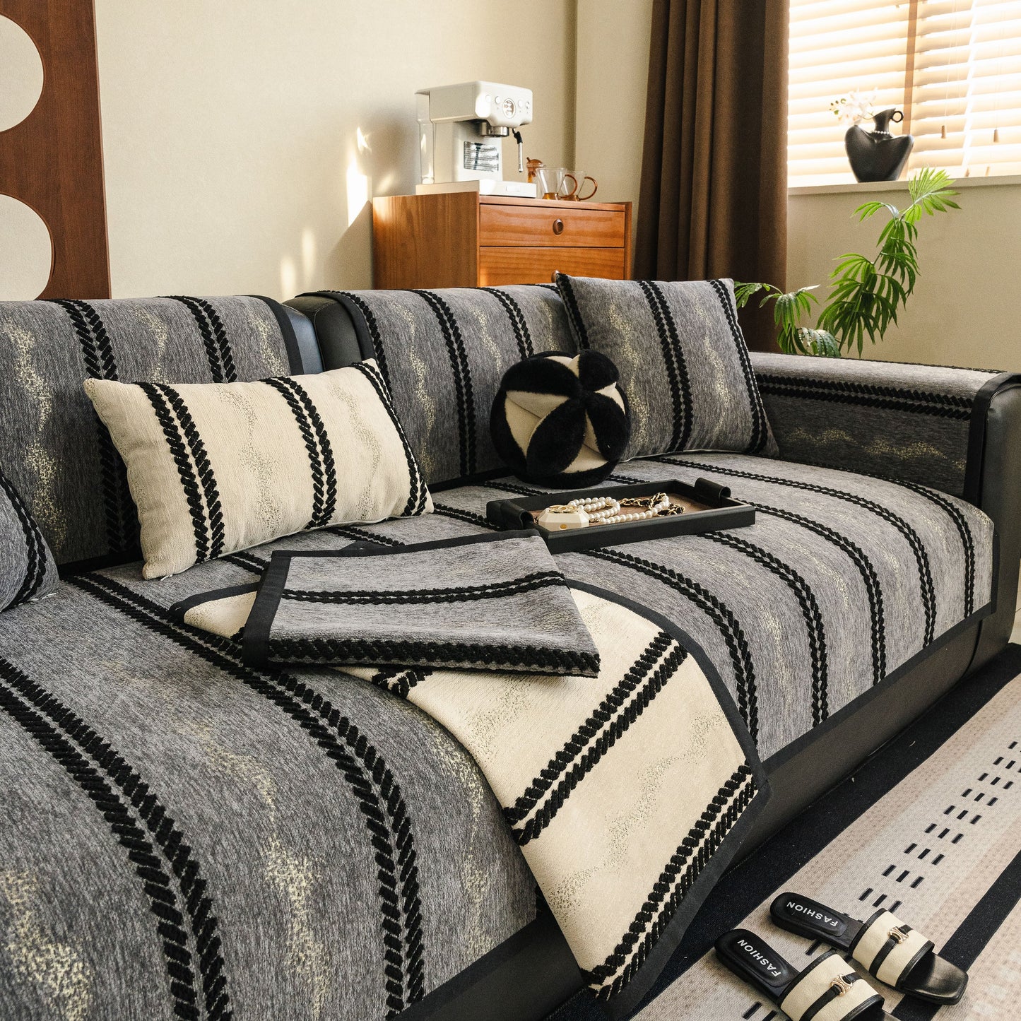 Non-Slip Sofa Cover with Thick Chenille Texture Woven Stripe Couch Protector Throw on a modern living room sofa set.
