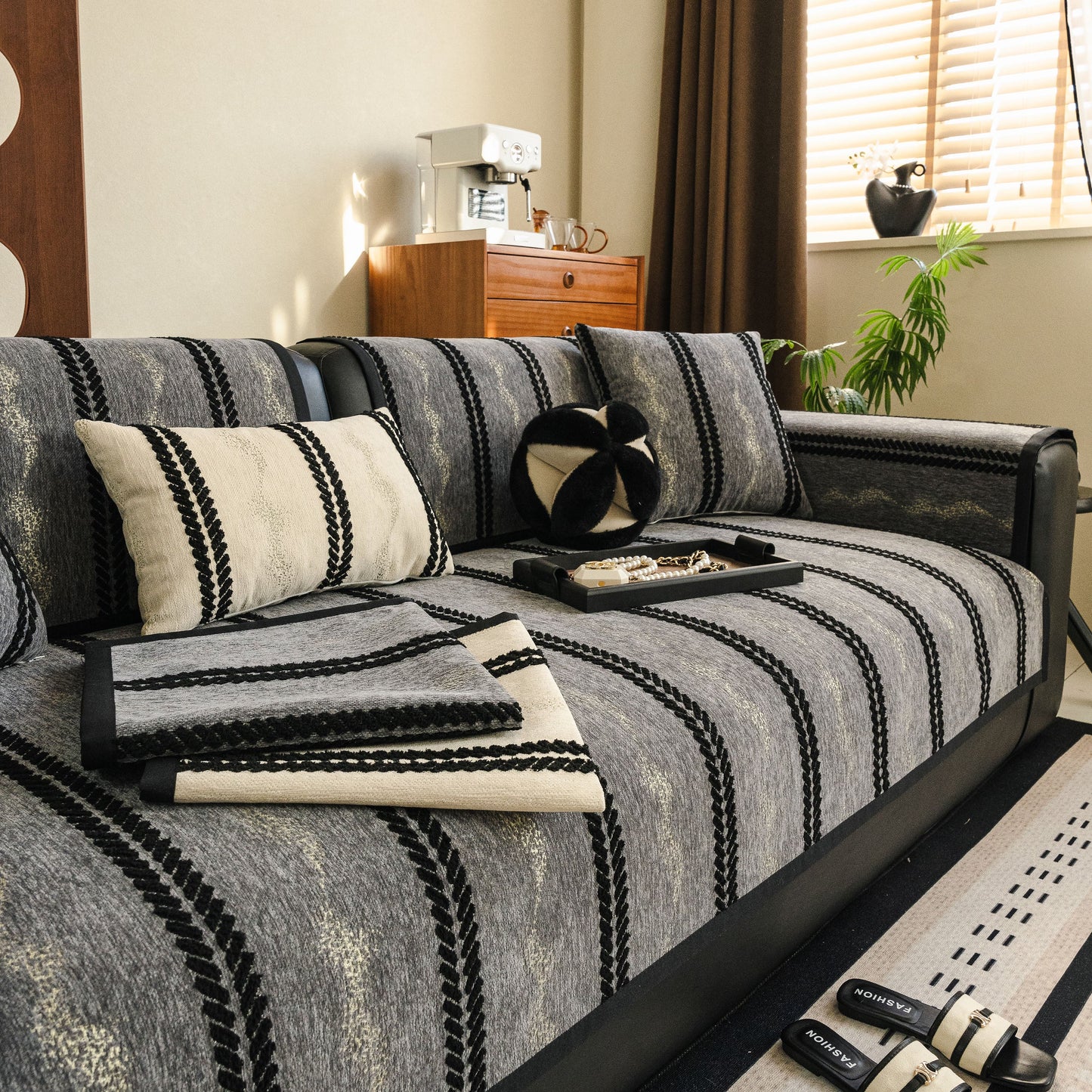 Living room with Non-Slip Sofa Cover with Thick Chenille Texture Woven Stripe Couch Protector Throw on black leather sofa