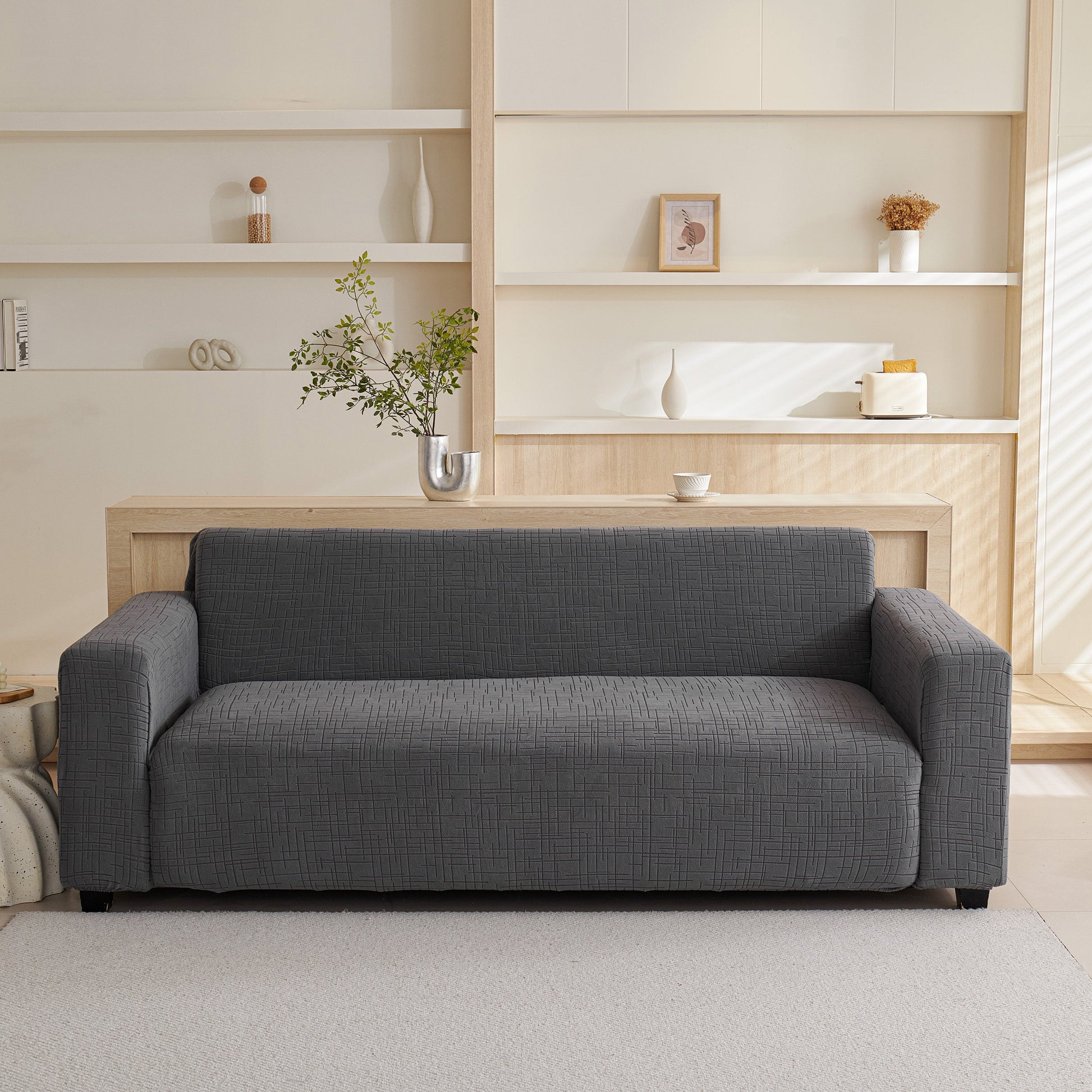 Gray sofa with Embossed Lines Couch Covers Stretchable Non-Slip & Washable Sofa Slipcovers in a modern living room setting.
