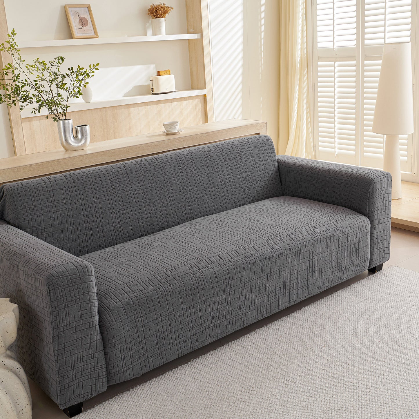 Embossed Lines Couch Covers Stretchable Non-Slip & Washable Sofa Slipcovers on a grey couch in a living room