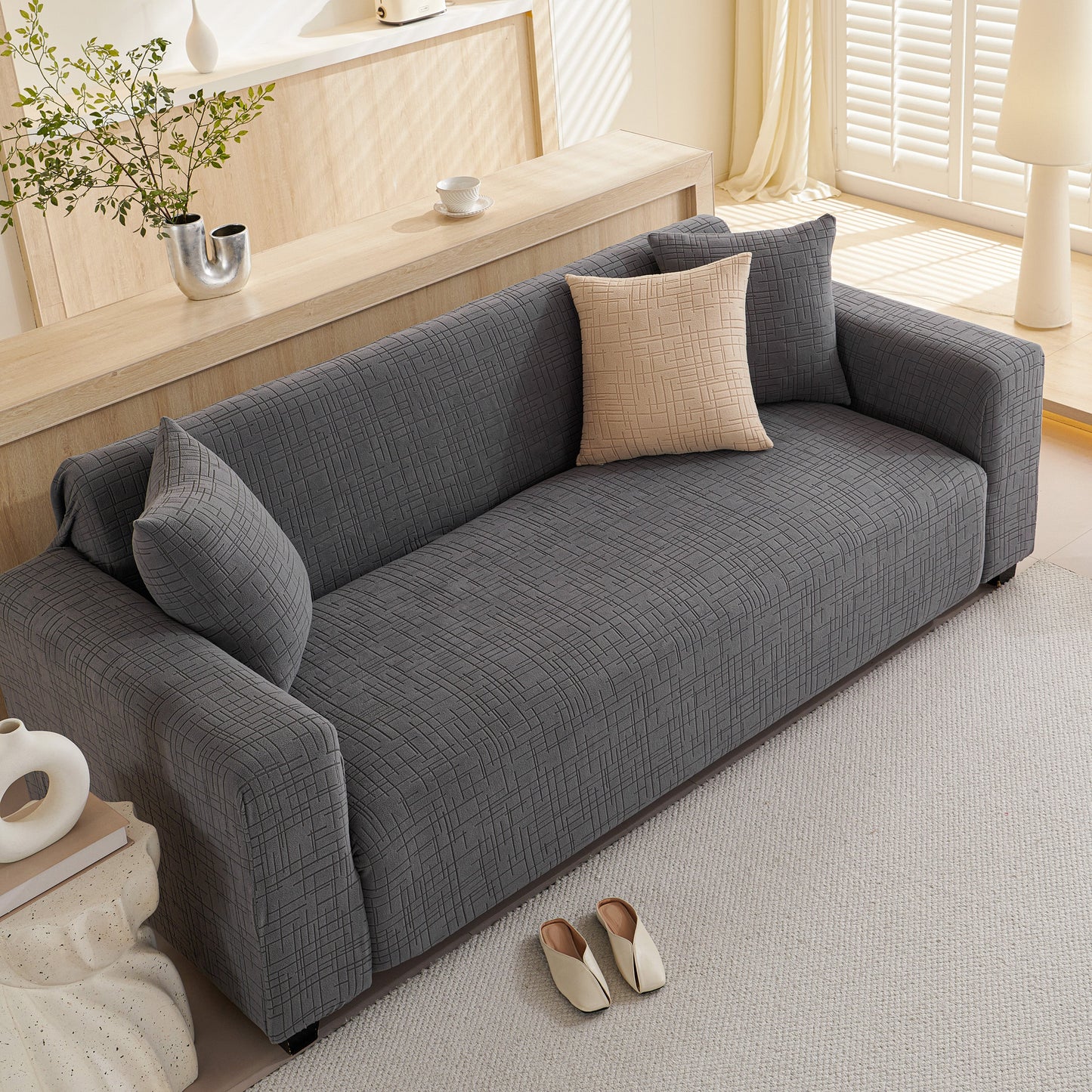 Embossed Lines Couch Covers Stretchable Non-Slip & Washable Sofa Slipcovers on a grey couch in a living room setting