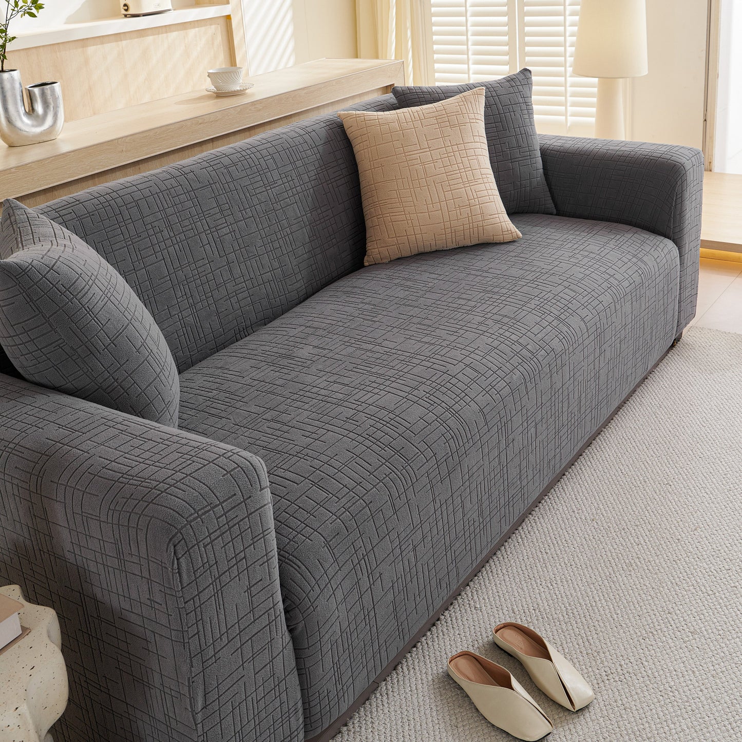 Embossed Lines Couch Covers Stretchable Non-Slip & Washable Sofa Slipcovers on a gray sofa