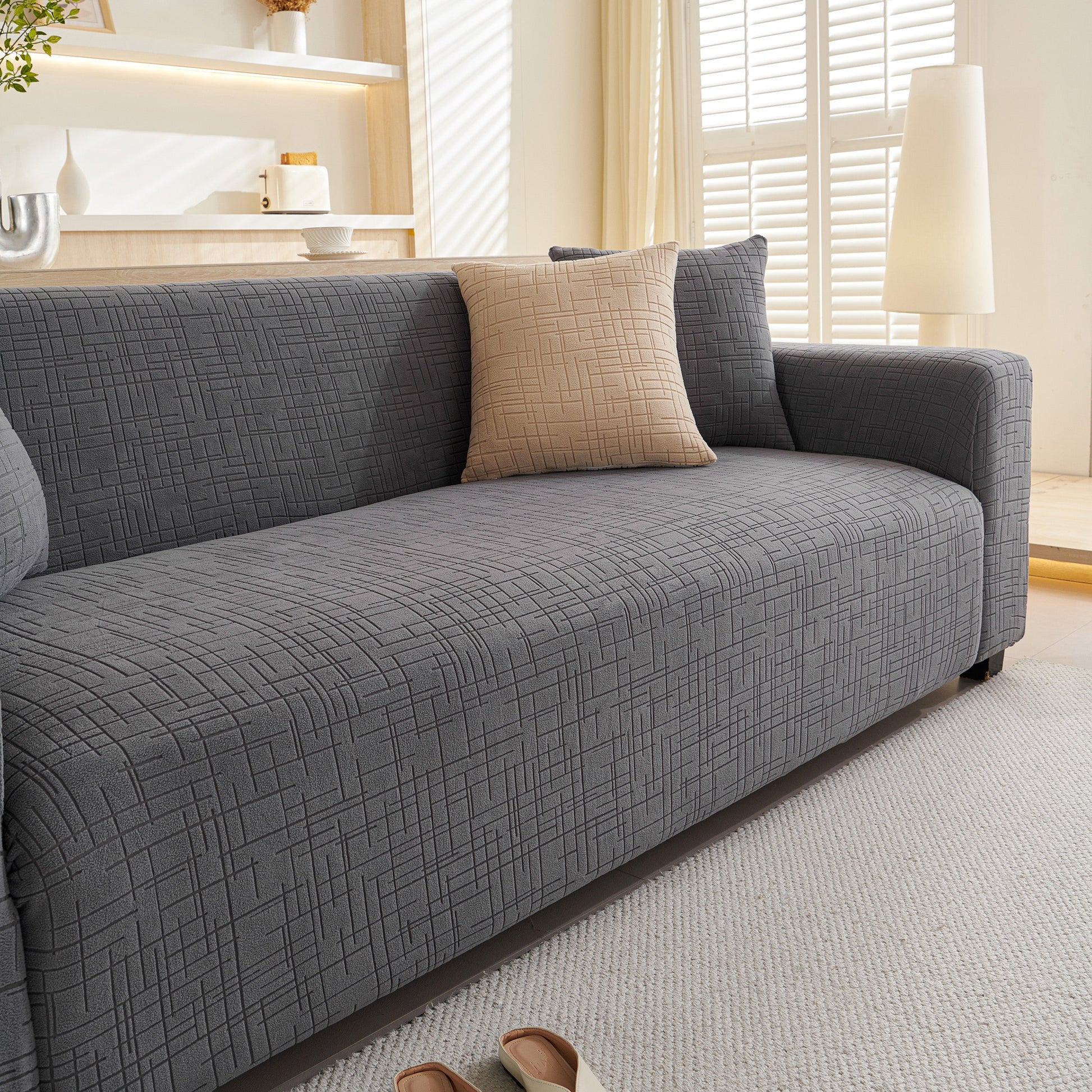Embossed Lines Couch Covers Stretchable Non-Slip & Washable Sofa Slipcovers in a living room setting, featuring a textured gray design.