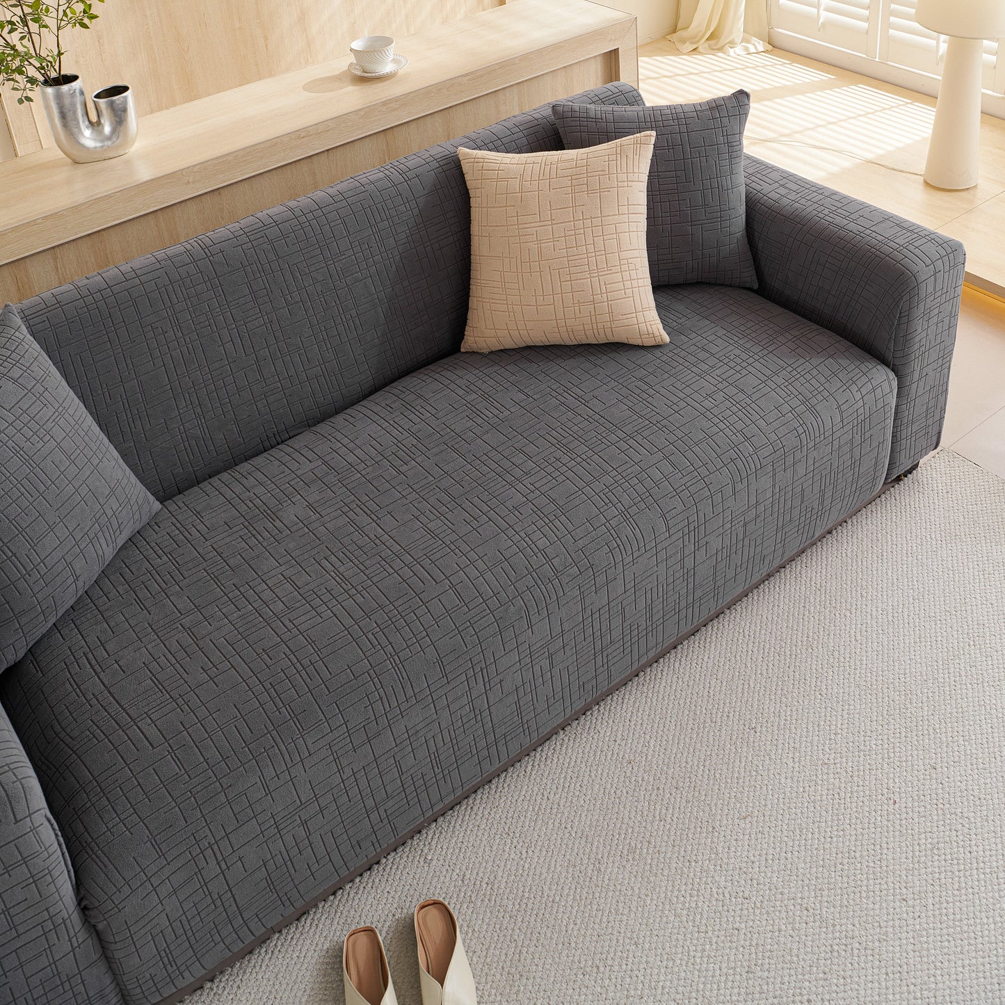 Embossed Lines Couch Covers Stretchable Non-Slip & Washable Sofa Slipcovers on a modern gray sofa