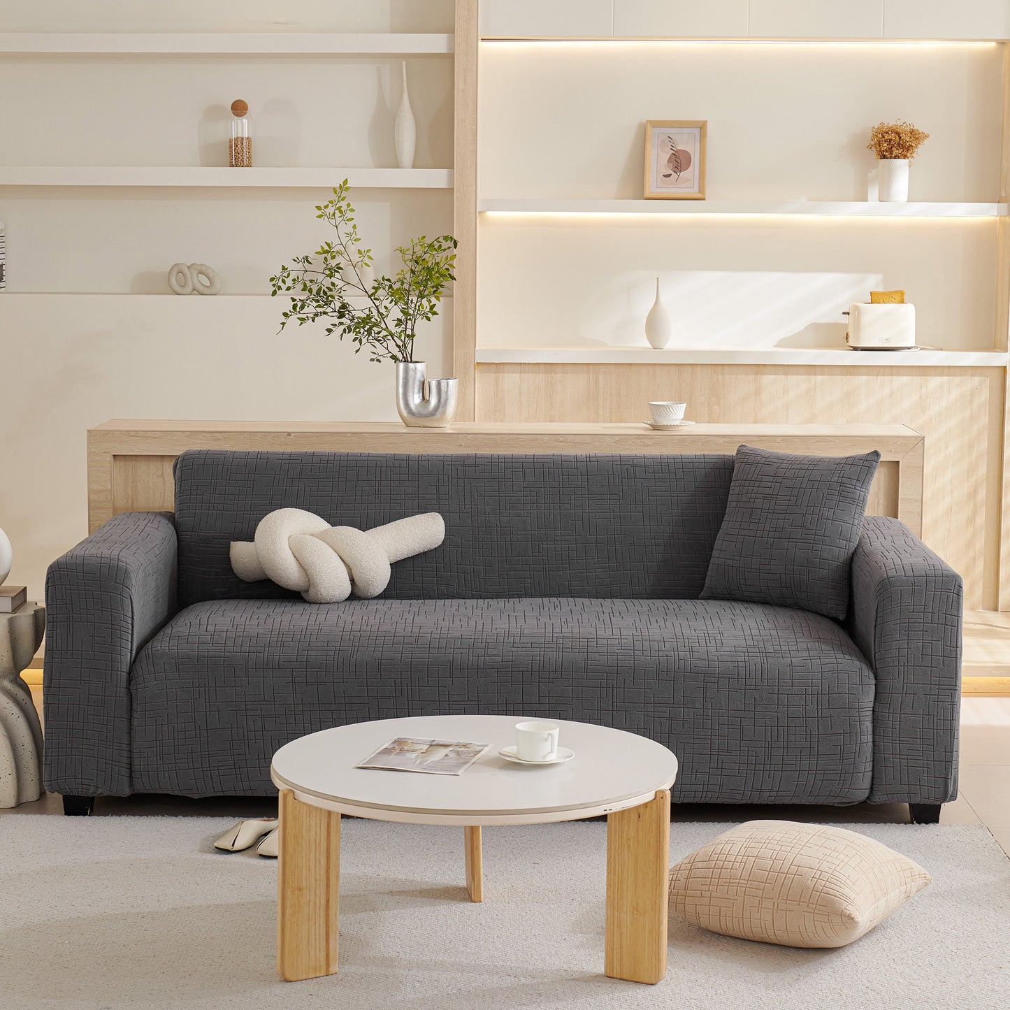 Embossed Lines Couch Covers Stretchable Non-Slip & Washable Sofa Slipcovers on a modern gray sofa in a living room.