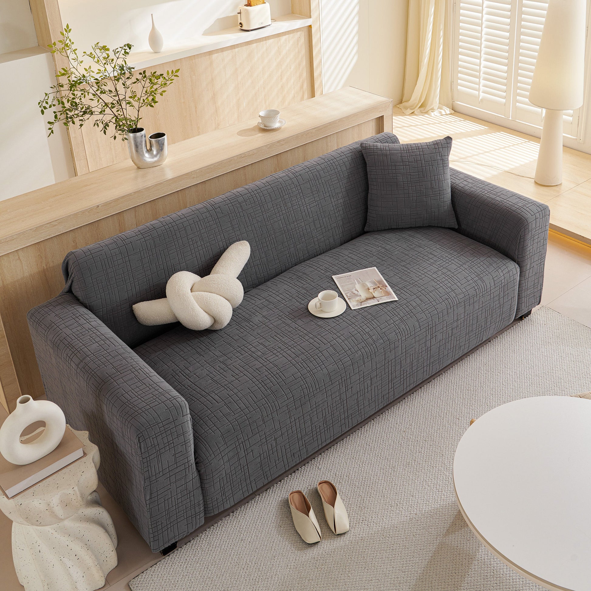 Modern living room with Embossed Lines Couch Covers Stretchable Non-Slip & Washable Sofa Slipcovers on a grey sofa.