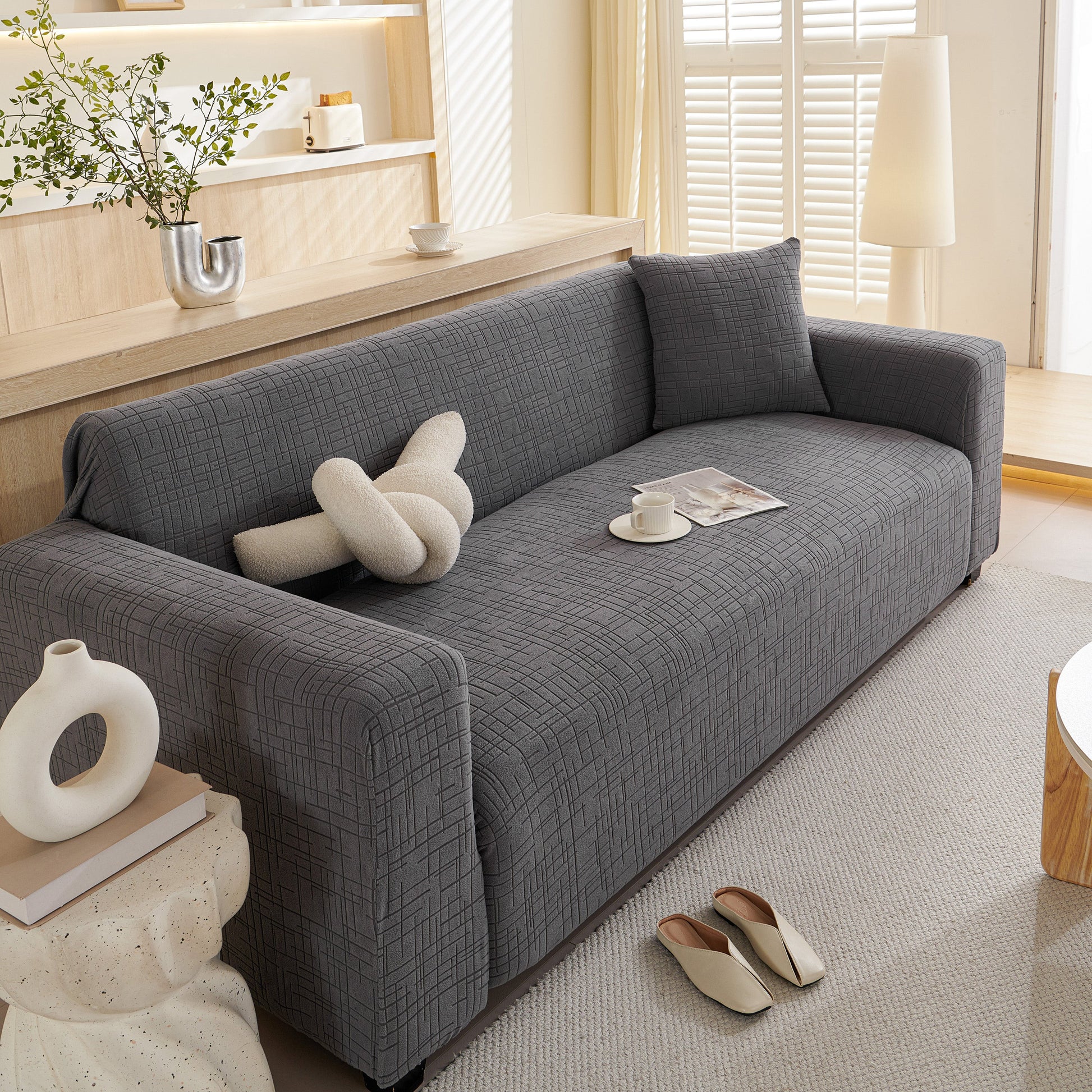 Embossed Lines Couch Covers Stretchable Non-Slip & Washable Sofa Slipcovers on a gray couch in a modern living room