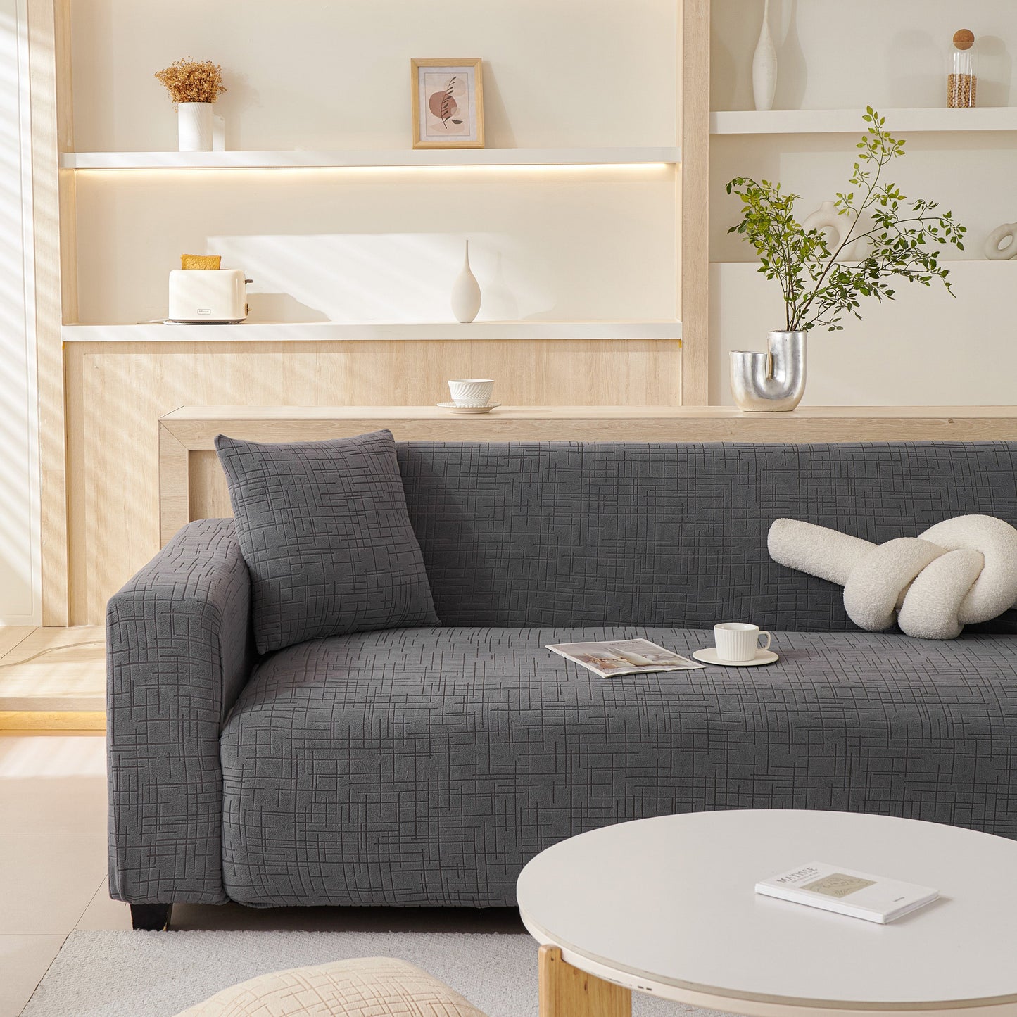 Modern living room with gray sofa featuring Embossed Lines Couch Covers Stretchable Non-Slip & Washable Sofa Slipcovers.