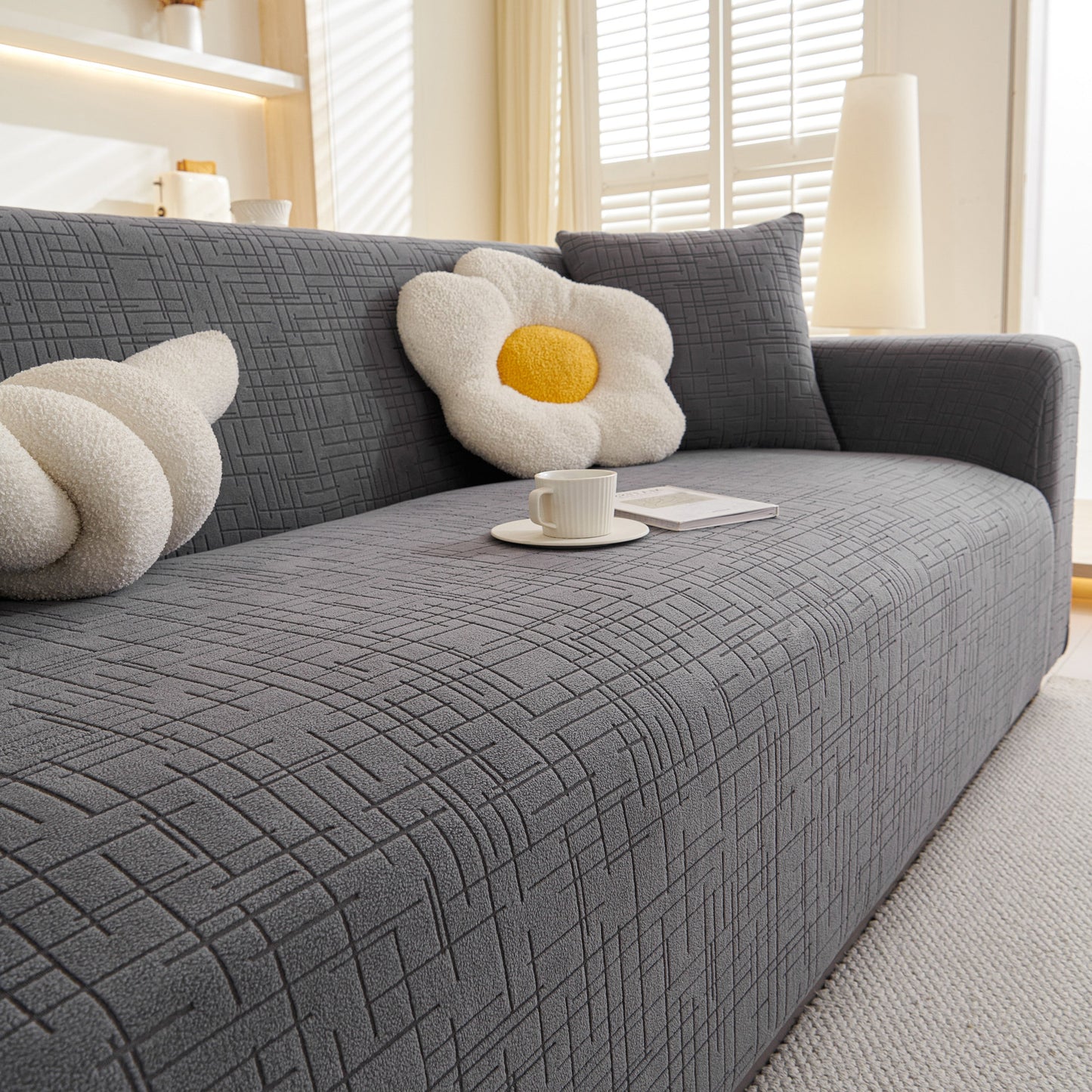 Embossed Lines Couch Covers Stretchable Non-Slip & Washable Sofa Slipcovers on a gray sofa with decorative pillows