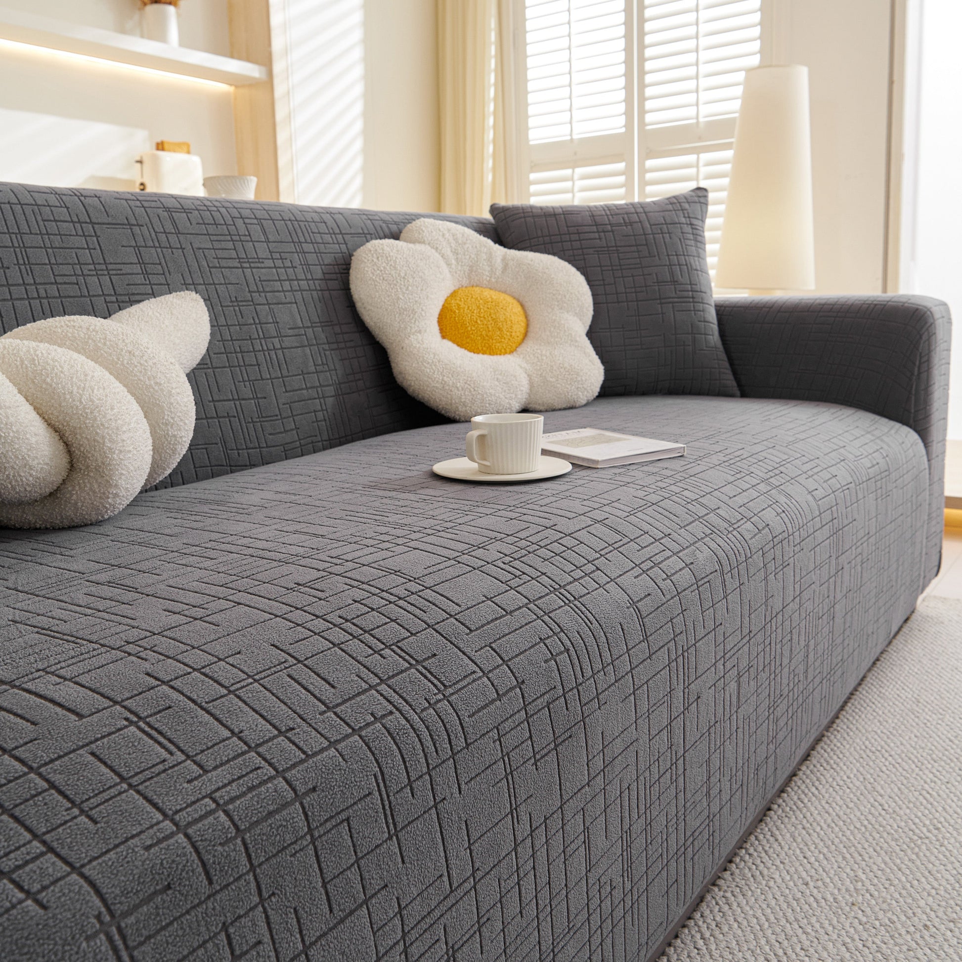 Embossed Lines Couch Covers Stretchable Non-Slip & Washable Sofa Slipcovers on a gray sofa with decorative pillows