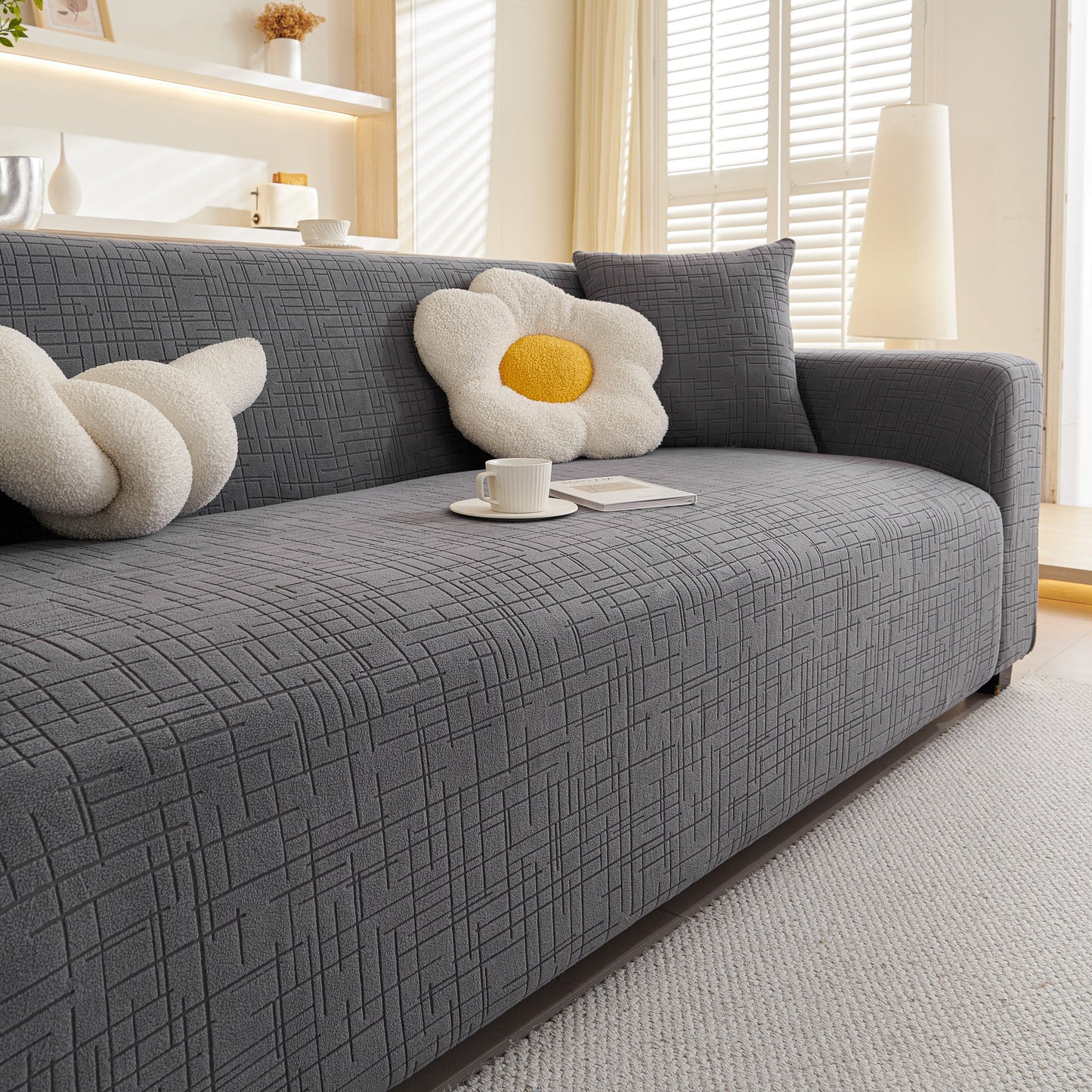 Embossed Lines Couch Covers Stretchable Non-Slip & Washable Sofa Slipcovers on a modern gray sofa with decorative pillows.